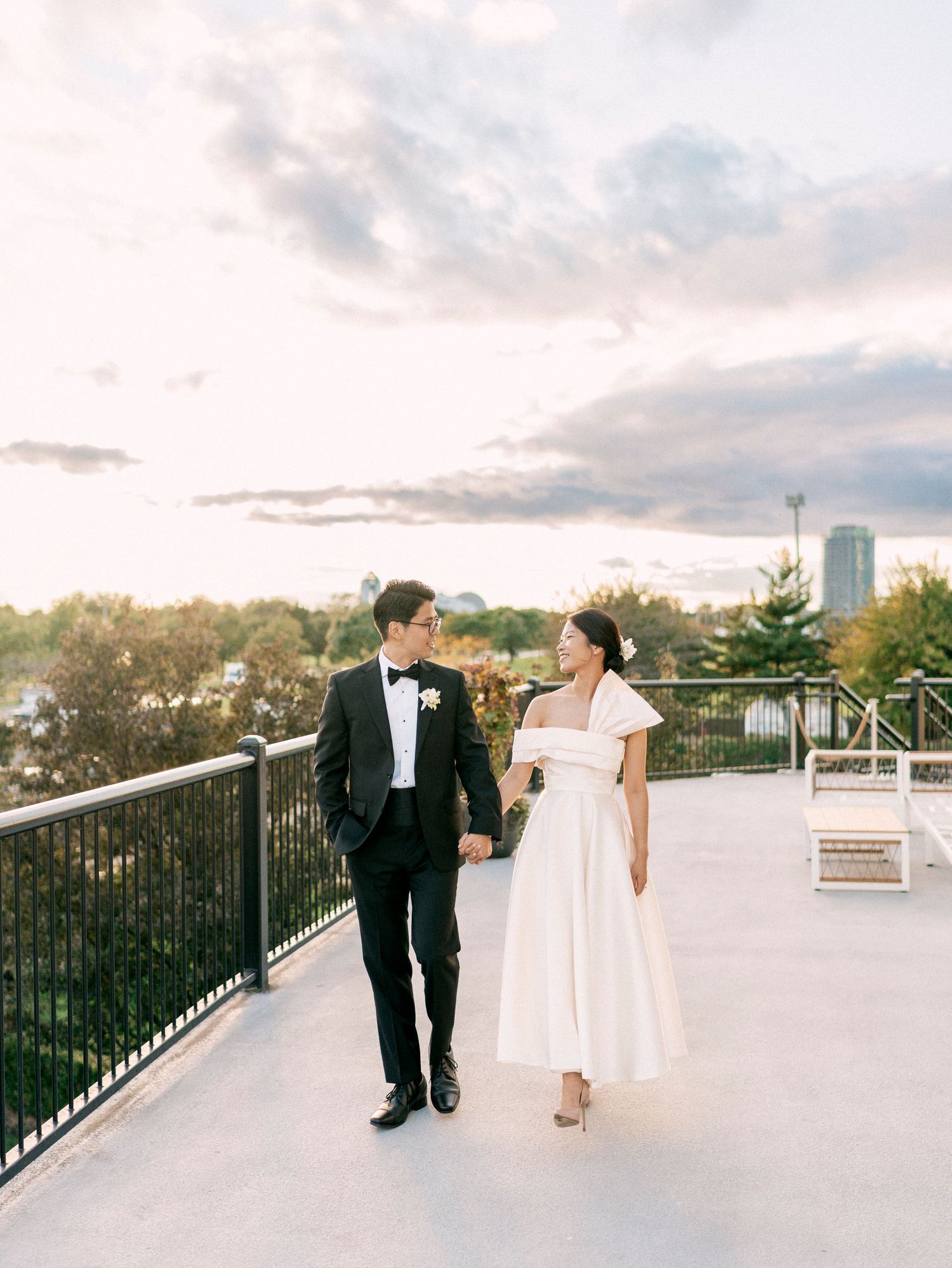 Elegant wedding portraits taken on a terrace during golden hour.