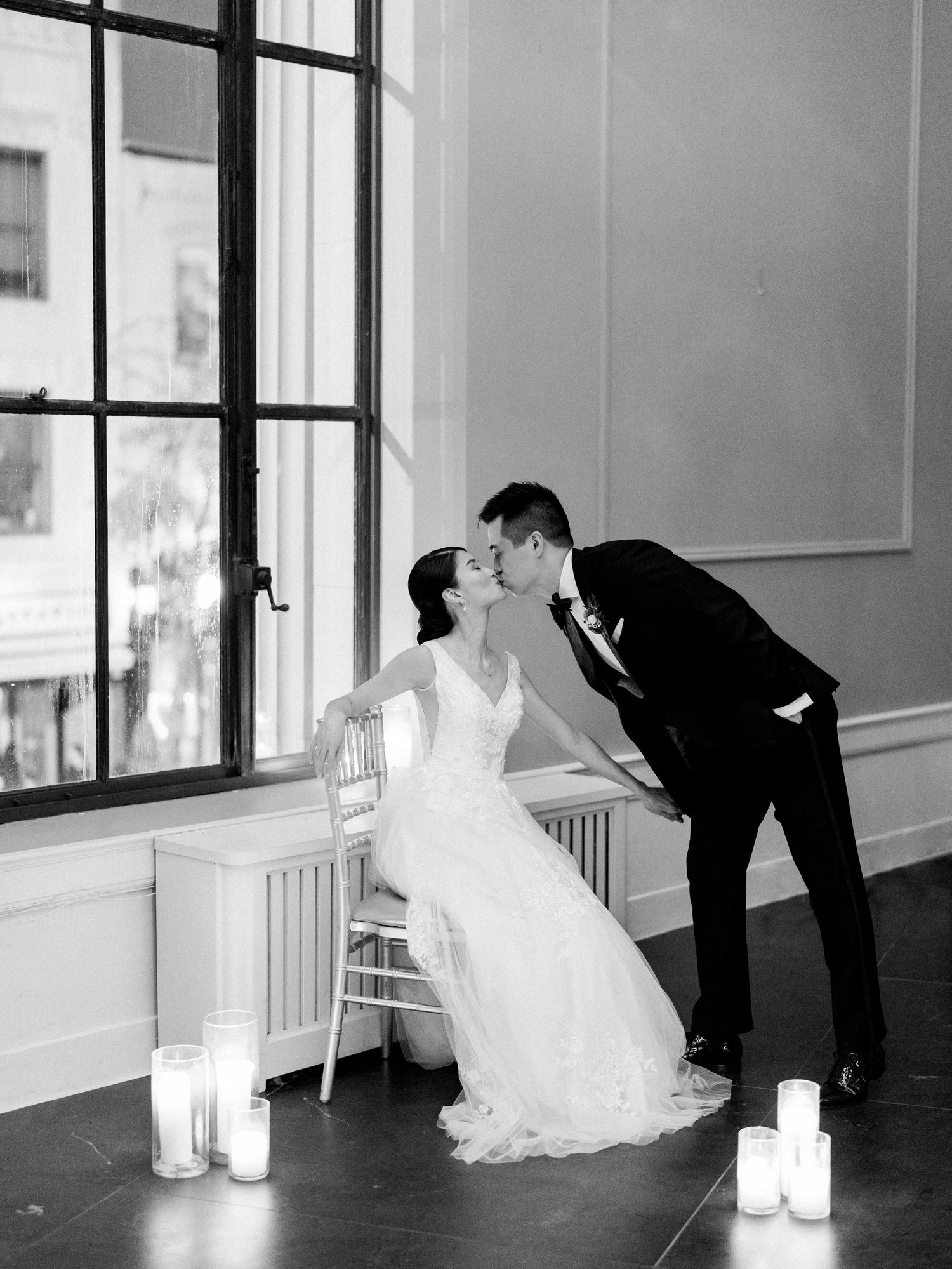 Romantic black and white wedding photos with candlelight in an elegant interior.