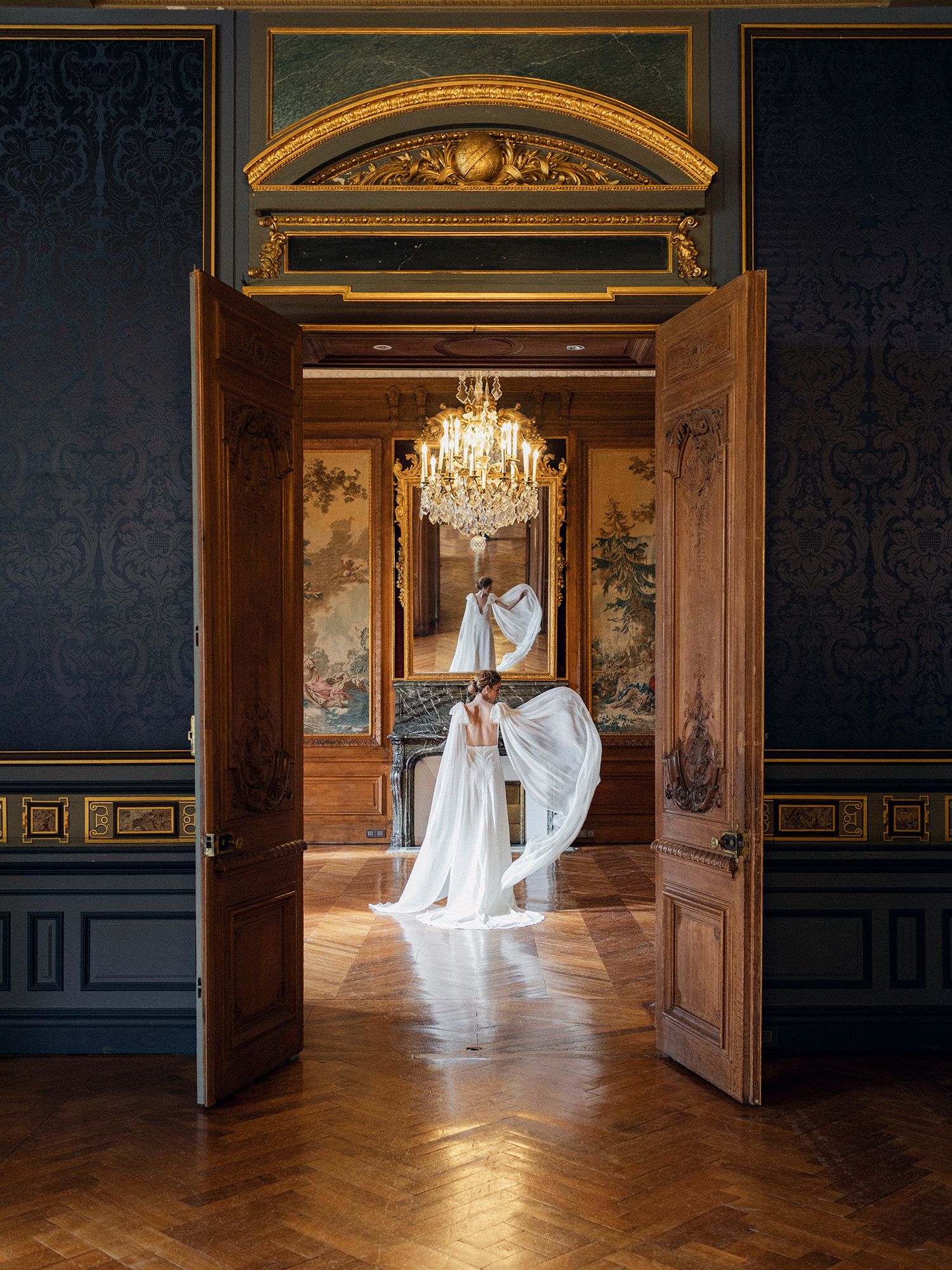 A series of elegant doorways in a grand palace showcase ethereal white gowns floating through ornate baroque rooms.
