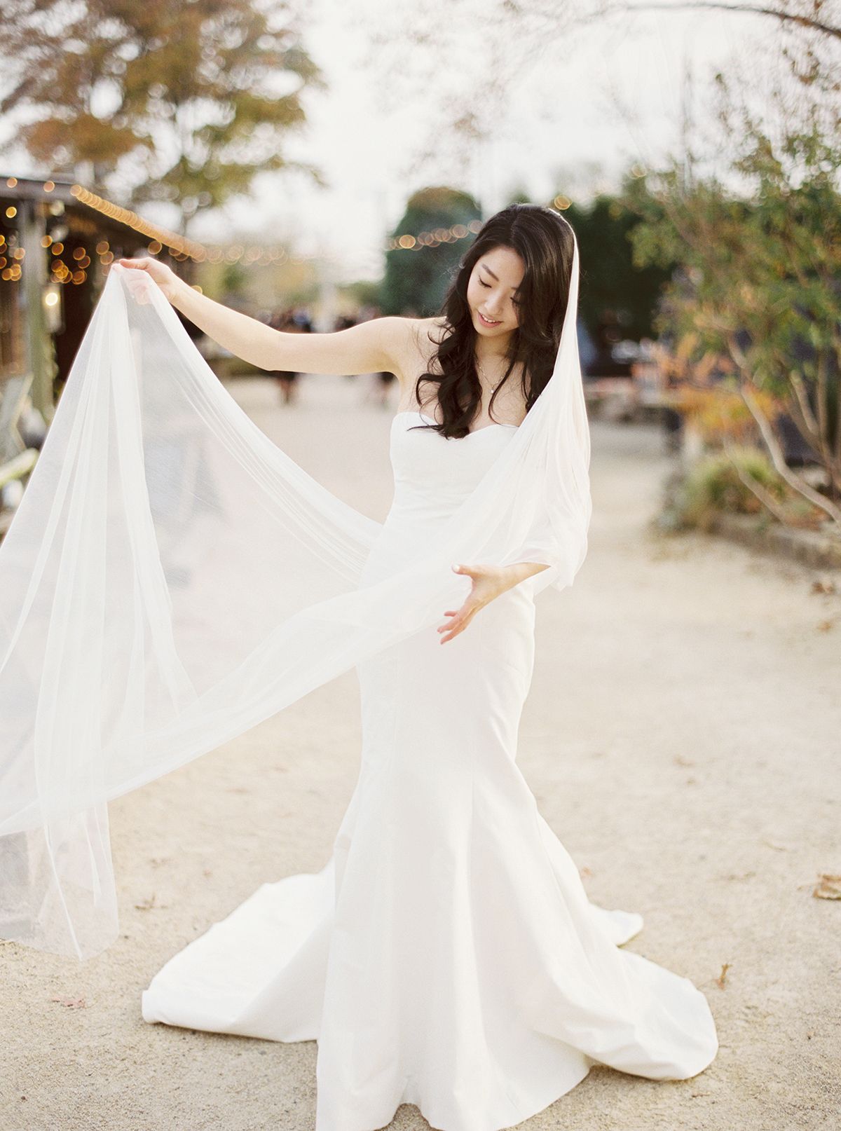 A flowing white wedding dress twirls gracefully in a desert landscape setting.