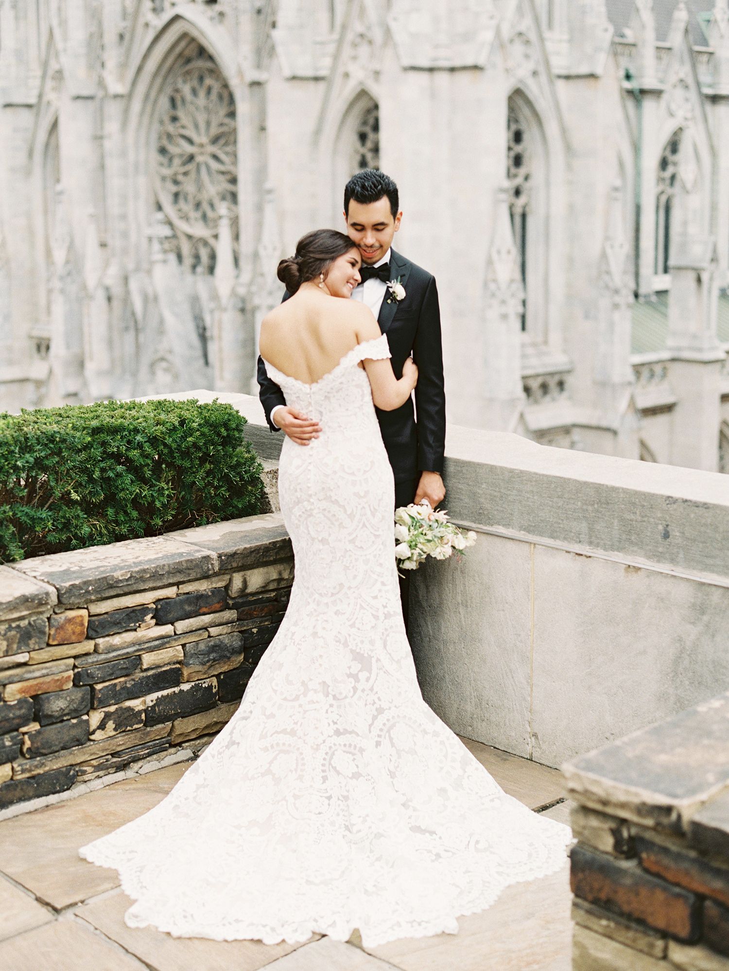 Romantic wedding portrait against gothic cathedral architecture with stone details. NYC wedding photographer.