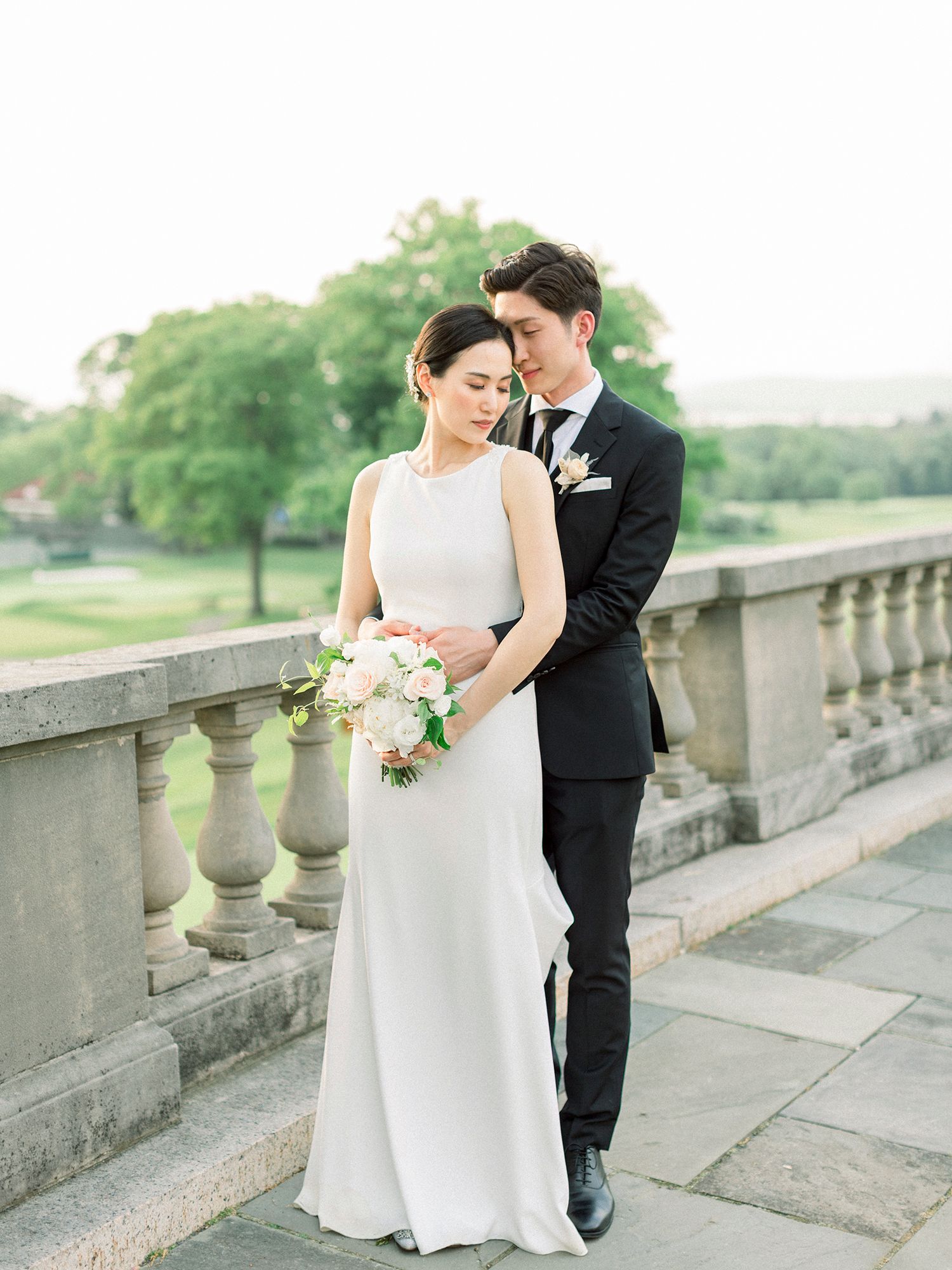 Romantic wedding portraits on a stone terrace with classic architectural details.