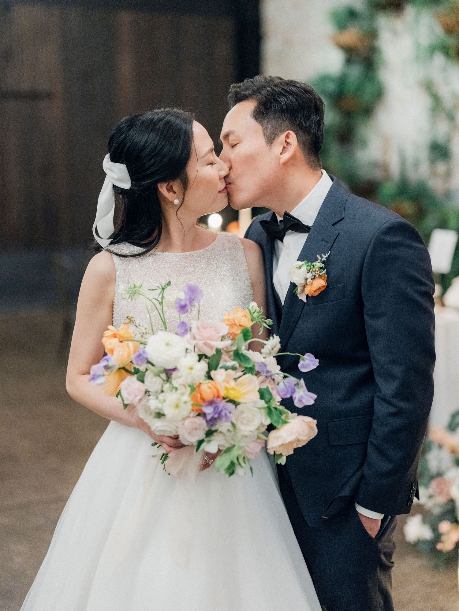 A romantic wedding moment captured with a beautiful floral bouquet in soft pastels.