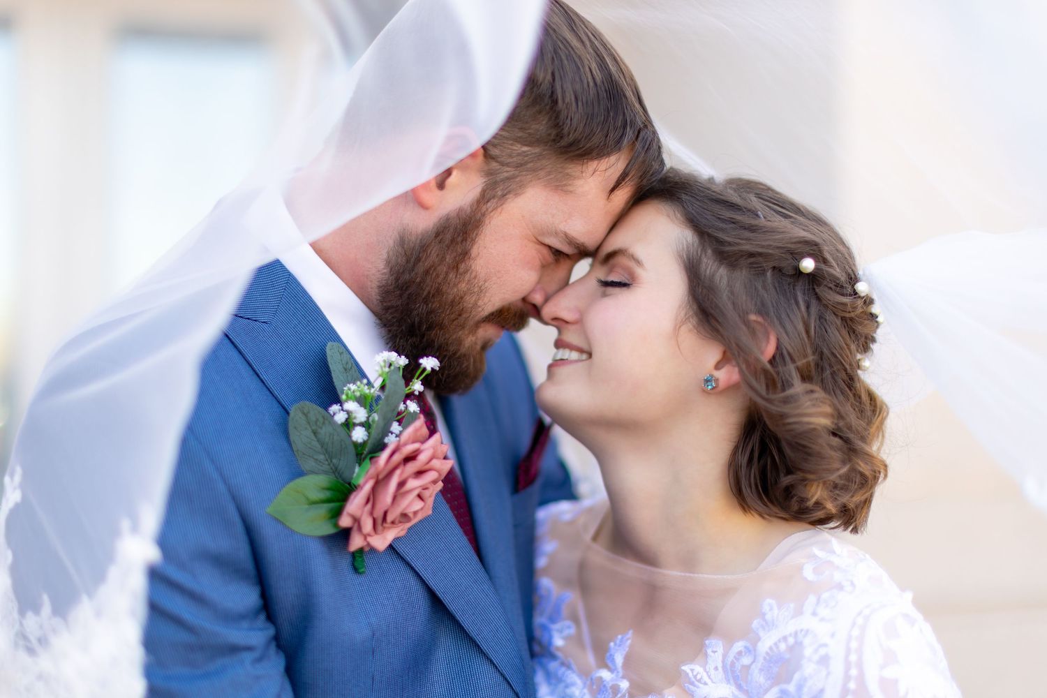 A romantic couple in wedding attire share tender moments in a series of intimate portrait photographs.