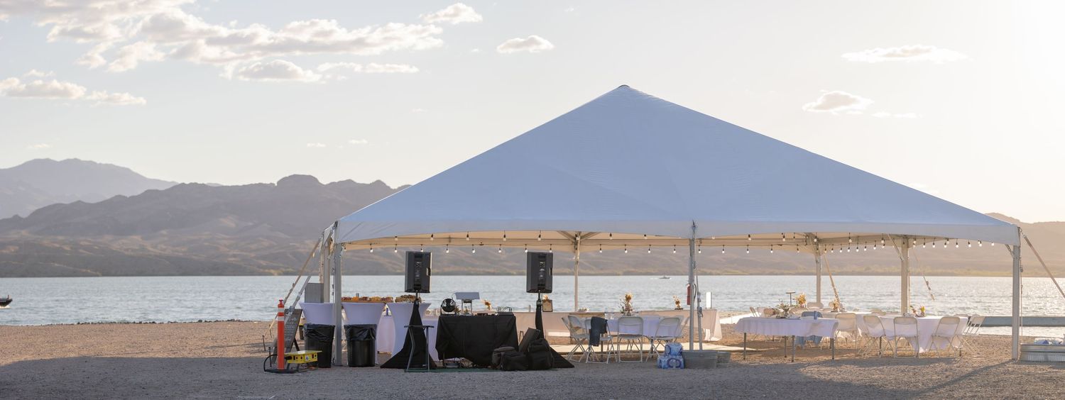 Desert gas station with blue mountain backdrop and rustic canopy stand against a pale sky in Lake Havasu City Arizona