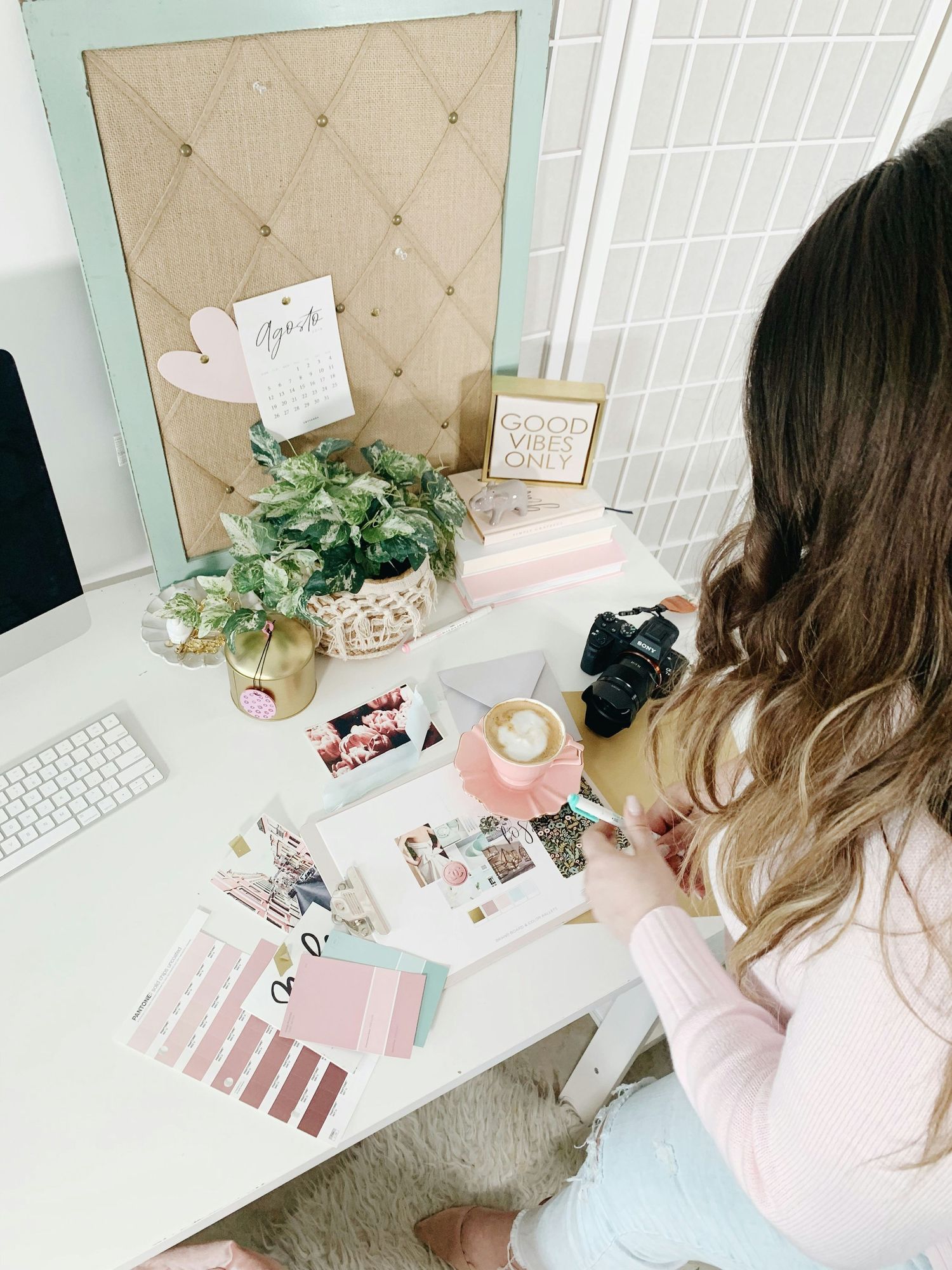 Creative workspace with mood board, camera, color swatches and design elements.