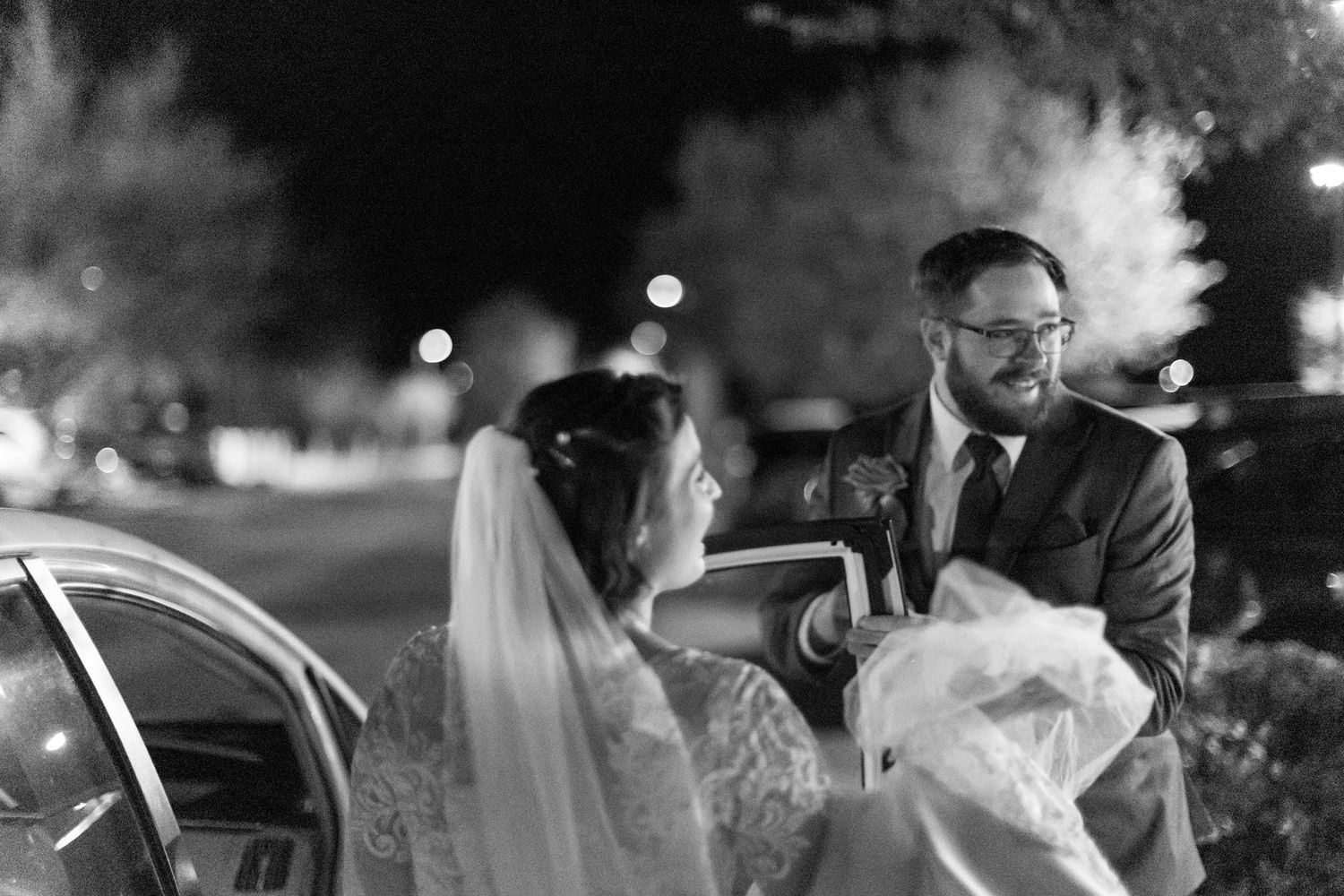 A black and white wedding photography collage showing intimate moments between couples and guests at a reception.