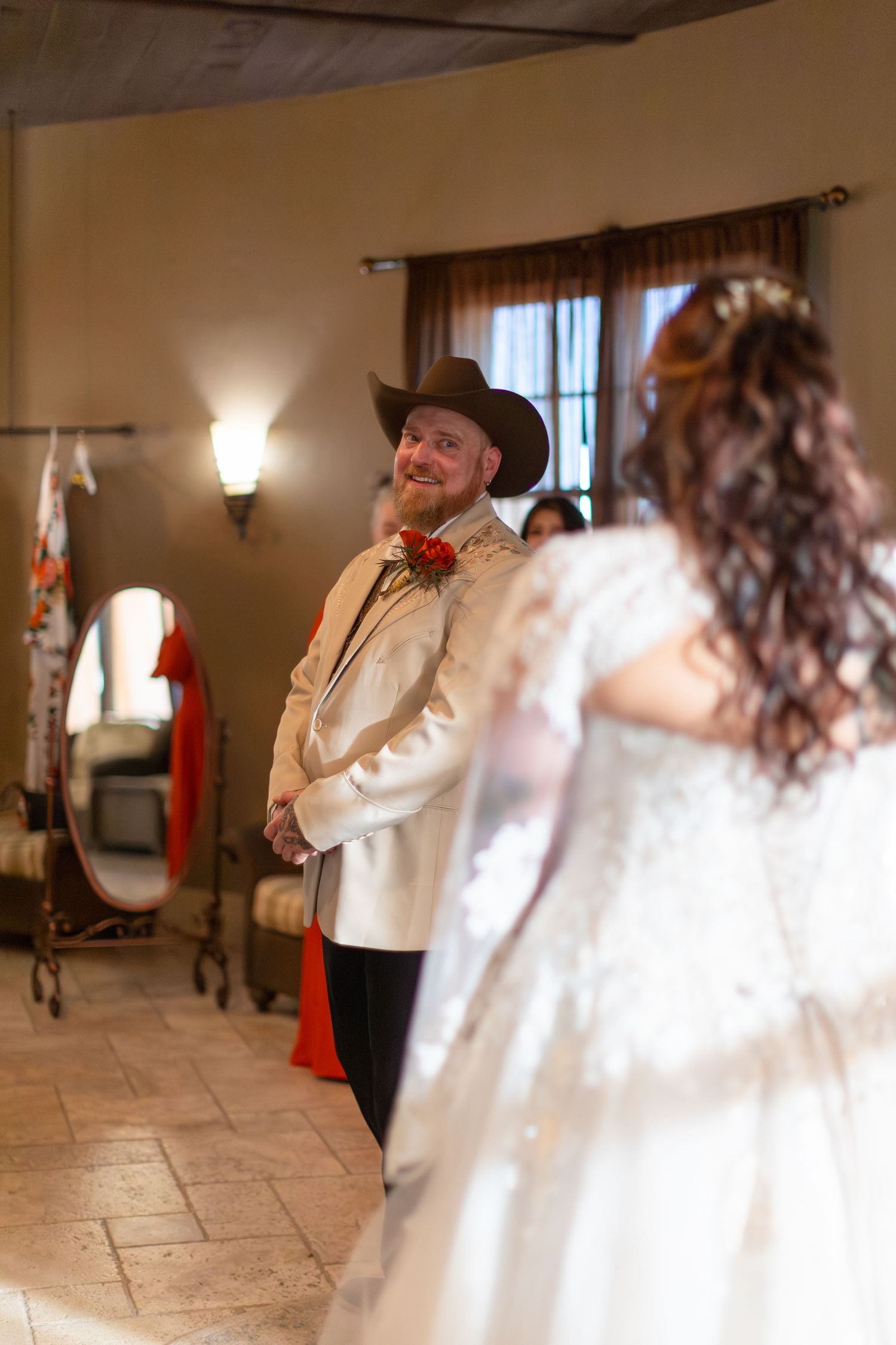 A couple in formal attire dance together in an elegant indoor venue with tiled floors and warm lighting at iron wolf lake havasu