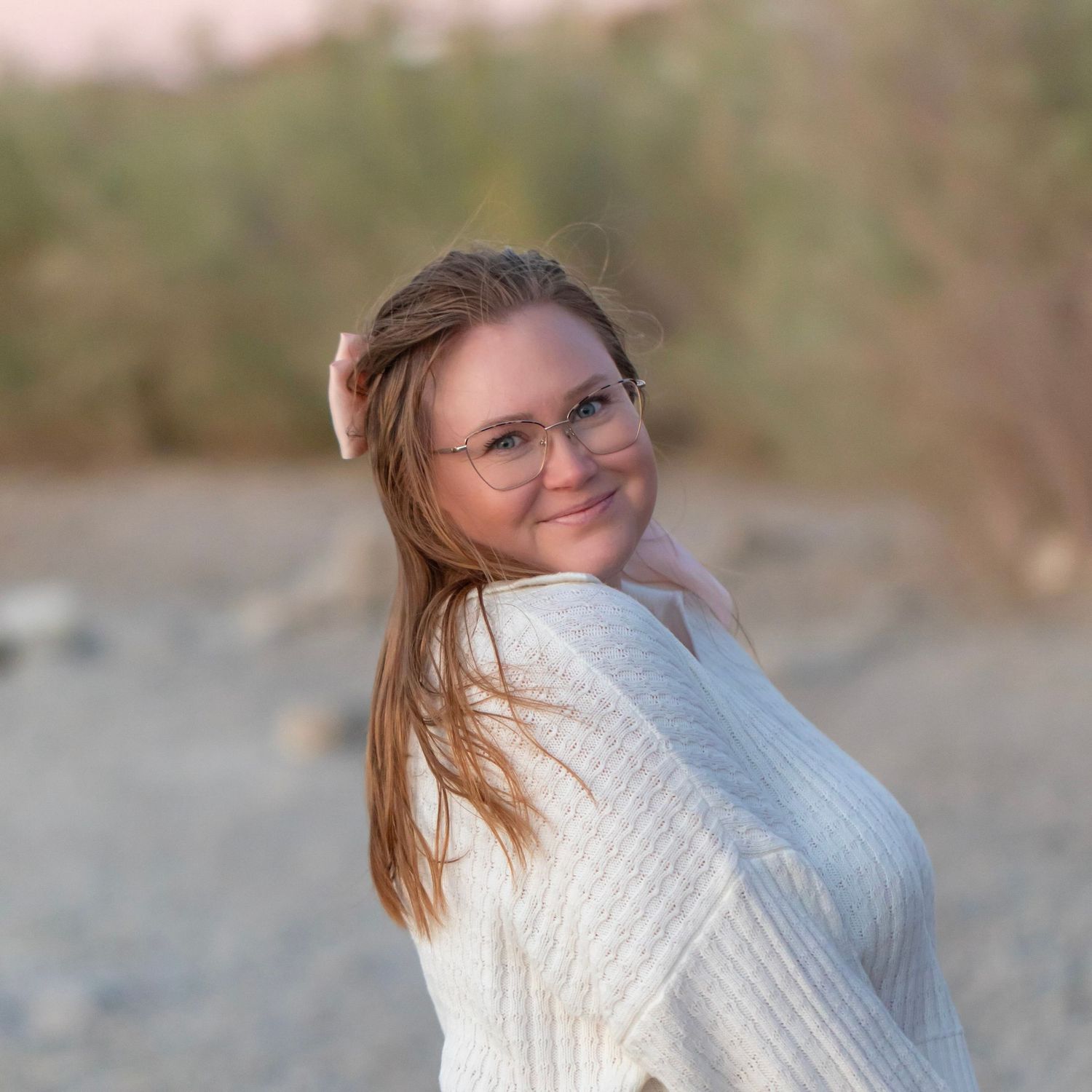 Arianna Hosea in white cable knit sweater poses against lake havasu landscape