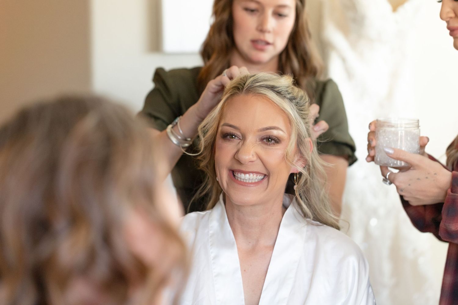 Stylist preparing bride's hair in bright dressing room at The Riviera Marina, Lake Havasu City wedding