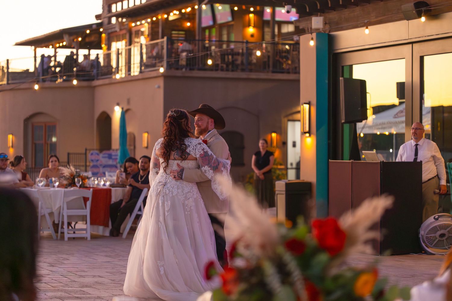 Wedding reception guests enjoying a festive dinner celebration at elegantly decorated tables at iron wolf lake havasu