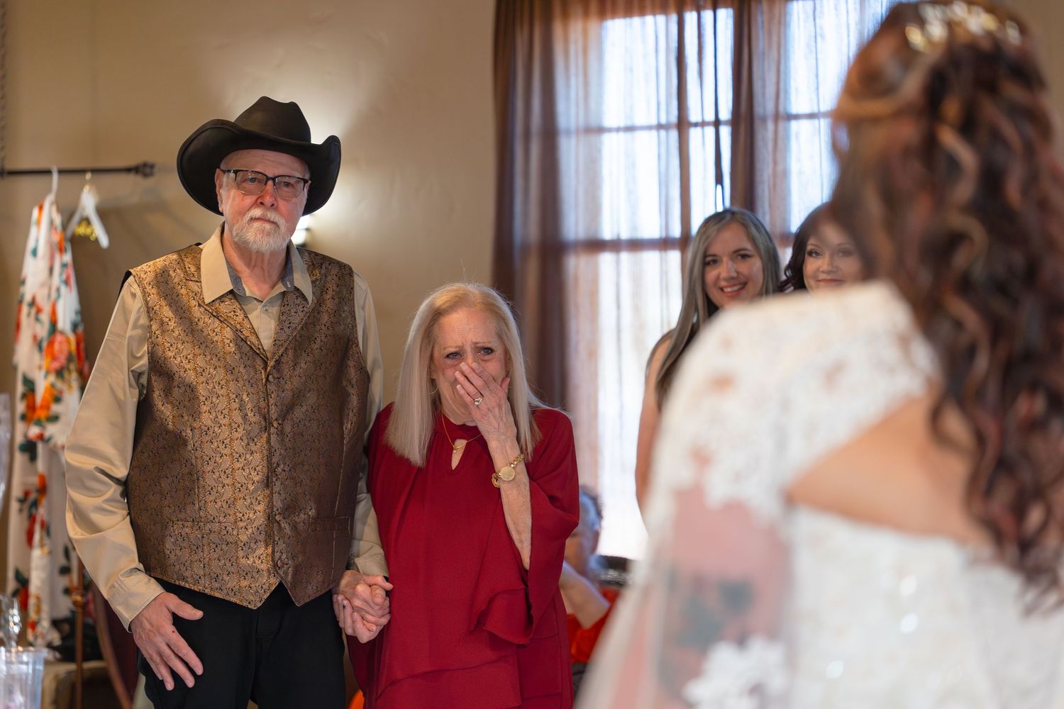 Parents of the bride and wedding party have a first look with the bride in Iron Wolf Lake Havasu City