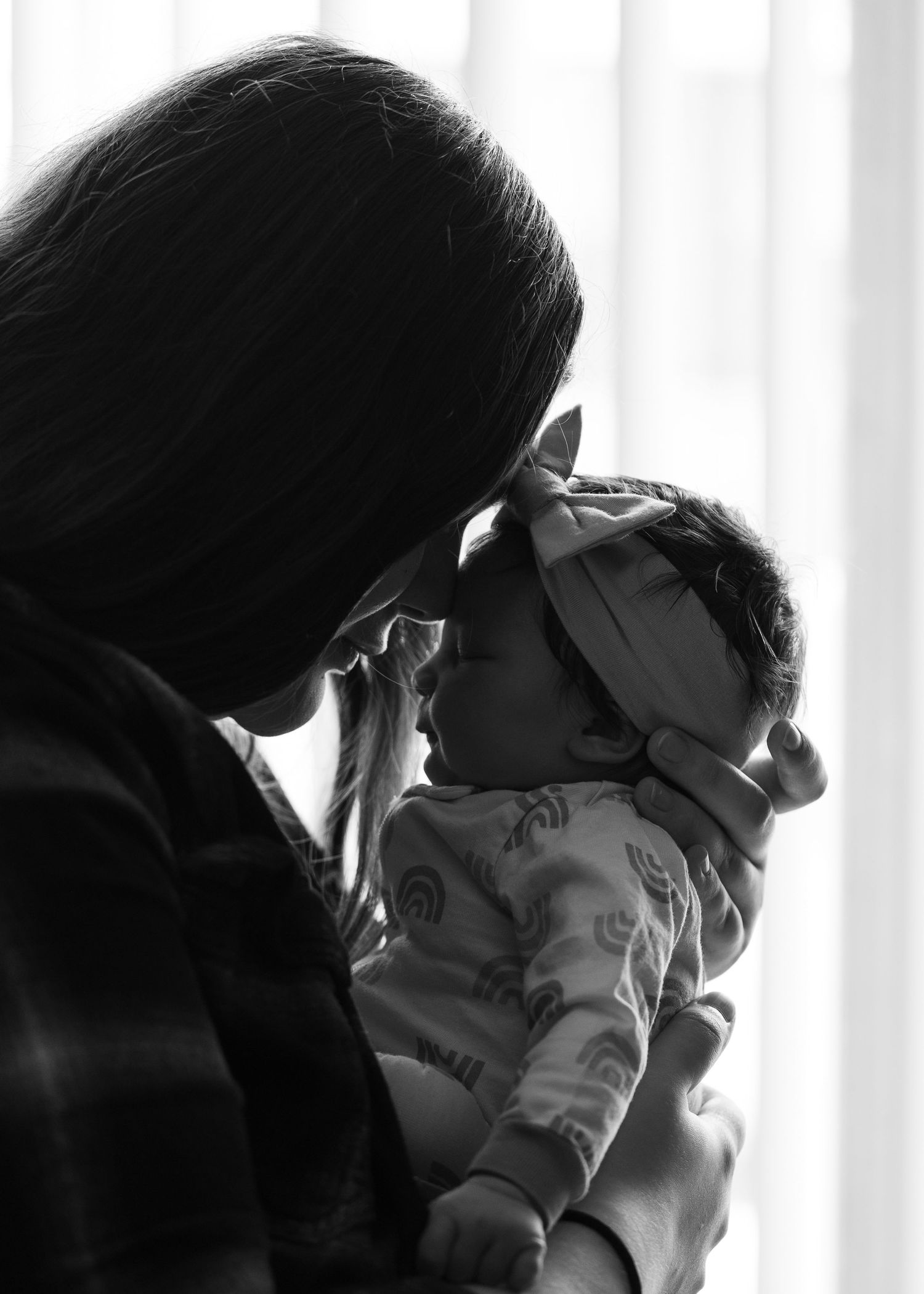 A series of black and white profile shots showing two people in intimate poses against a light background.