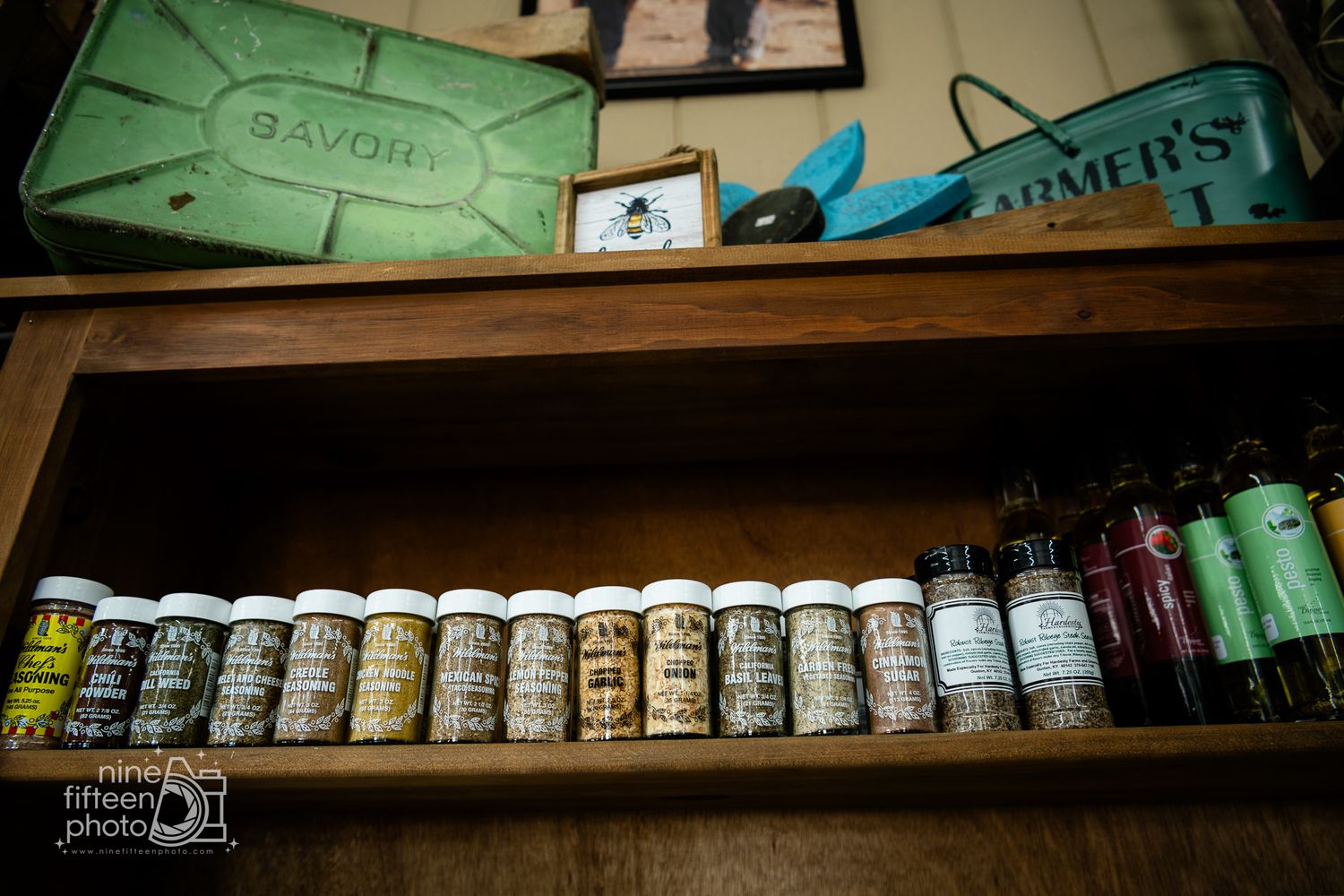 Spice and seasoning jars displayed on rustic wooden shelves inside the farm market at Hardesty Farms & Greenhouses.