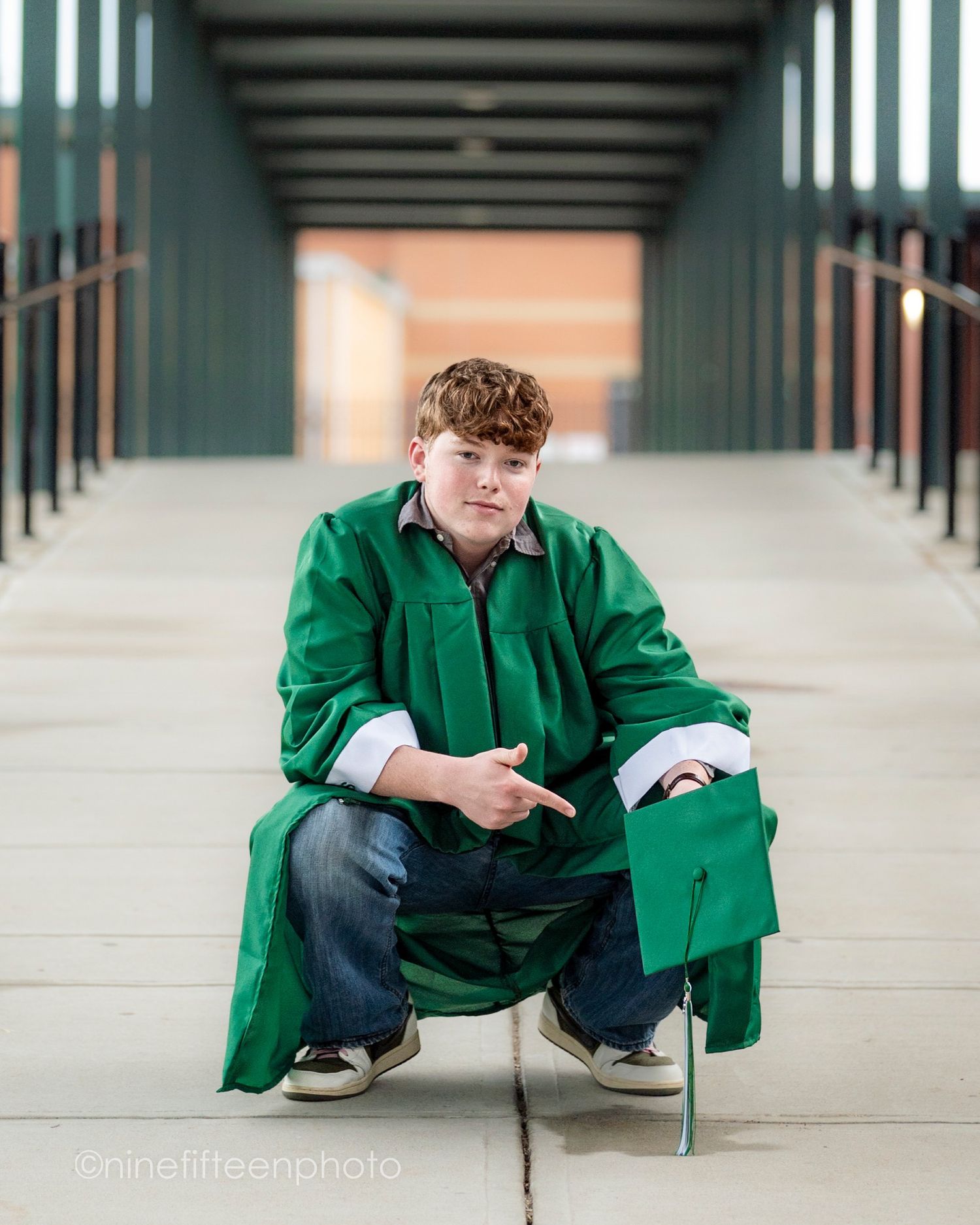 Senior graduation photo in cap and gown taken outdoors in Kentucky by ninefifteenphoto for Class of 2025.