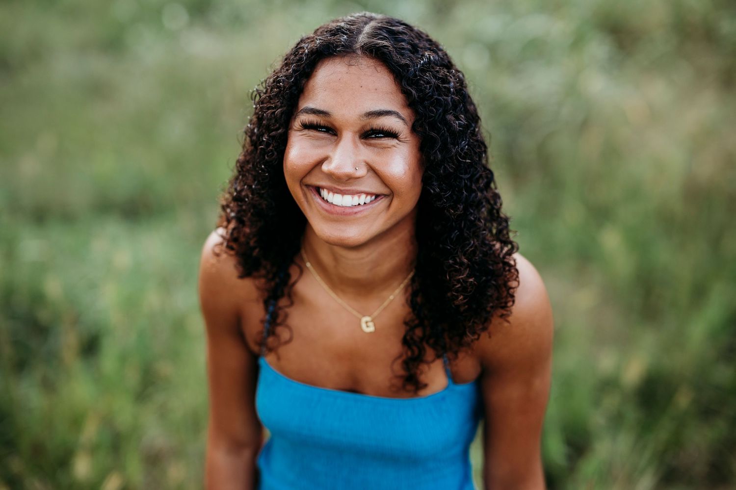 enior photo of Bella smiling in blue dress during Brandenburg Kentucky sunset session by ninefifteenphoto