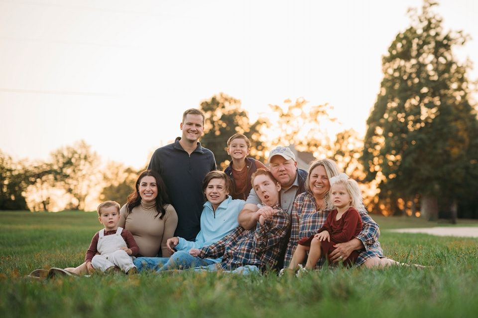 Golden hour family portrait sitting in a field, Brandenburg KY family photographer serving Meade County Kentucky.
