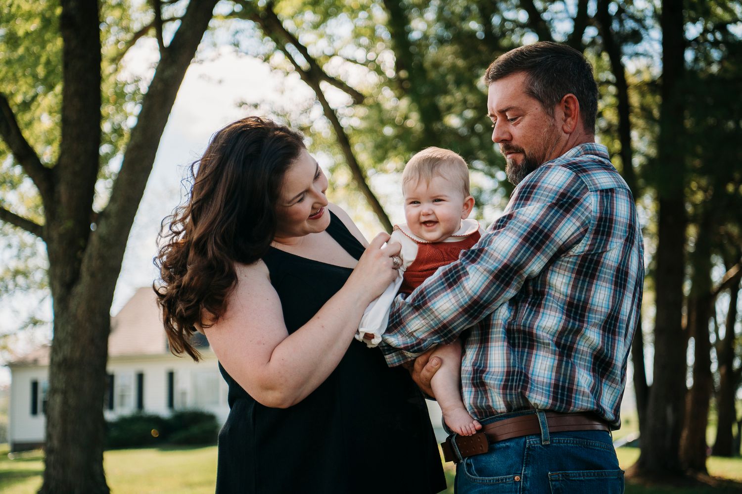 Joyful family farmhouse photo session in Battletown KY with their smiling baby captured by ninefifteenphoto