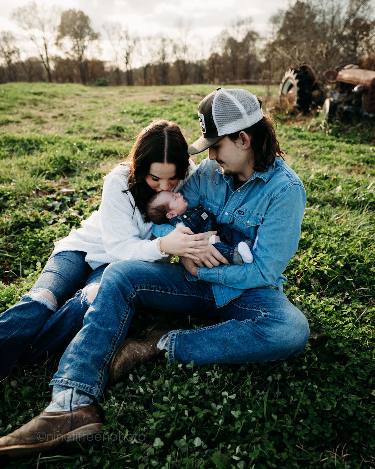 Custer KY newborn lifestyle photo of Kaylin and Caleb with their baby Devin, captured by ninefifteenphoto in rustic golden light.