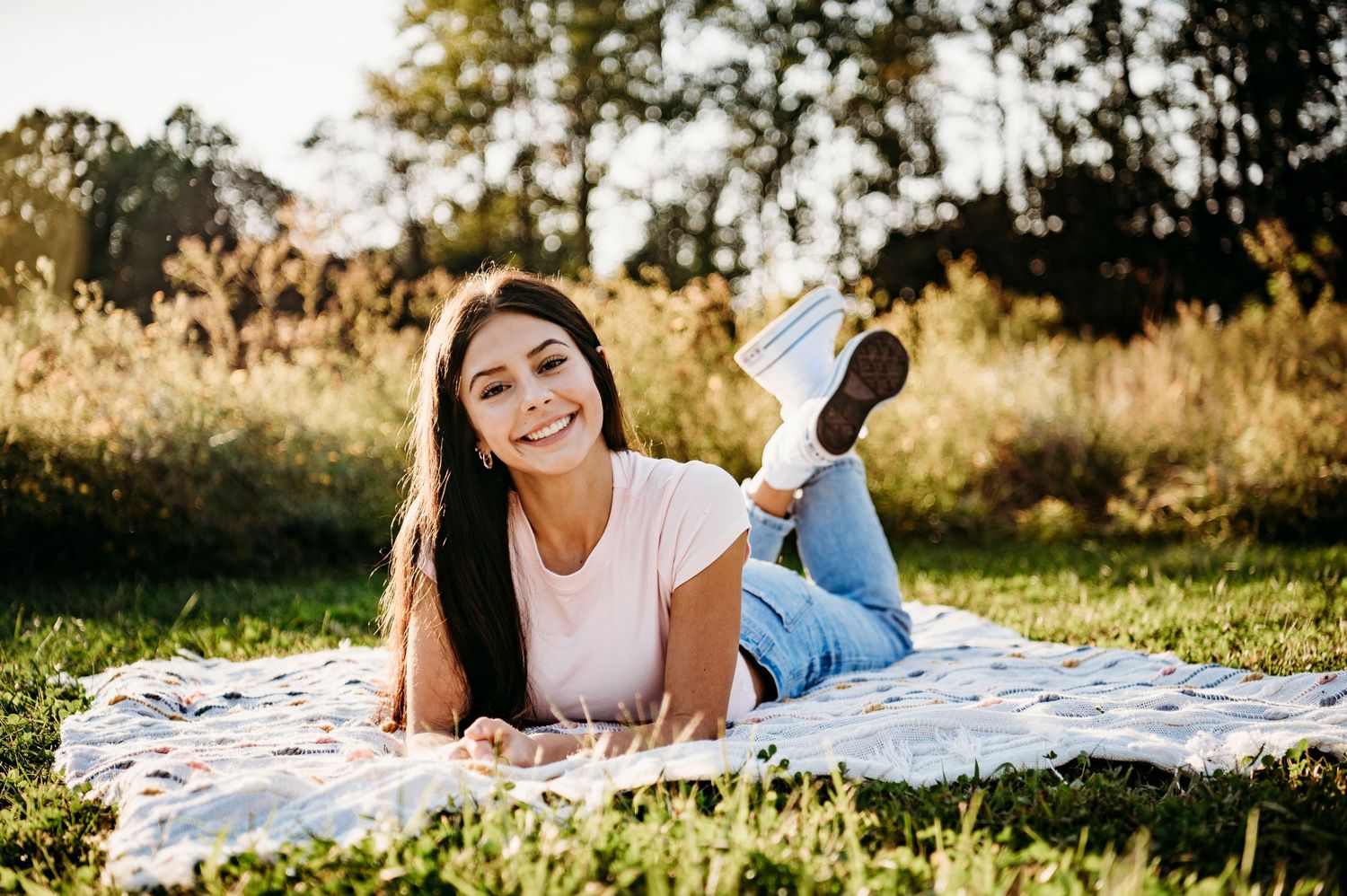 Emily relaxing on a blanket at Otter Creek Park during her senior photo session in Brandenburg Kentucky.