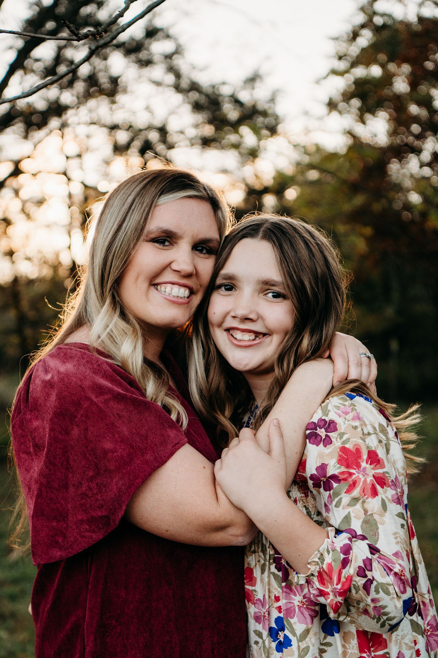 Mother and daughter smiling together in warm fall sunlight during Guston Kentucky family session