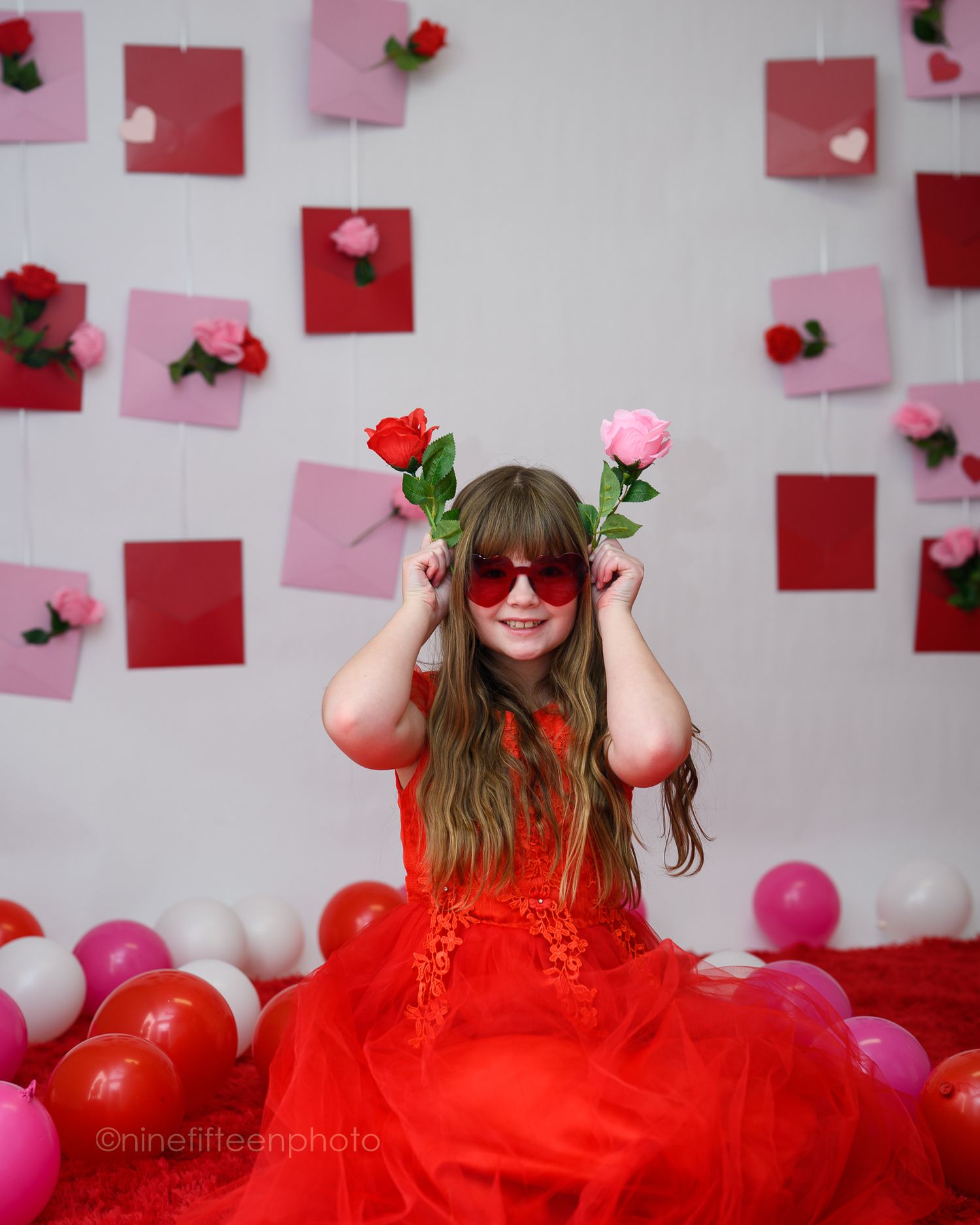 Valentine mini session with girl in red dress and heart backdrop, ninefifteenphoto Meade County KY children photographer.