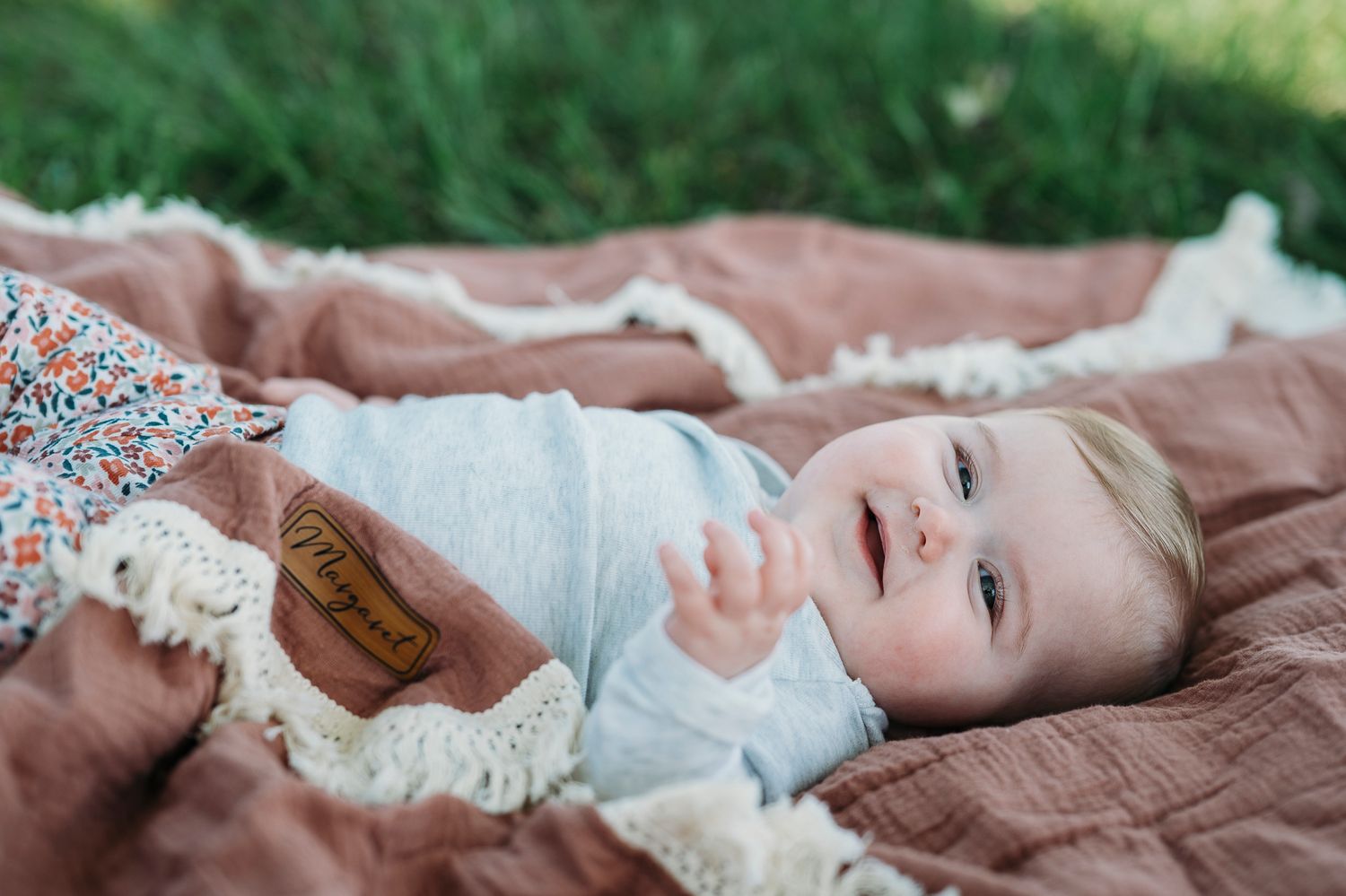 Lifestyle baby portrait on a cozy blanket during a Battletown farmhouse photo session captured by ninefifteenphoto.