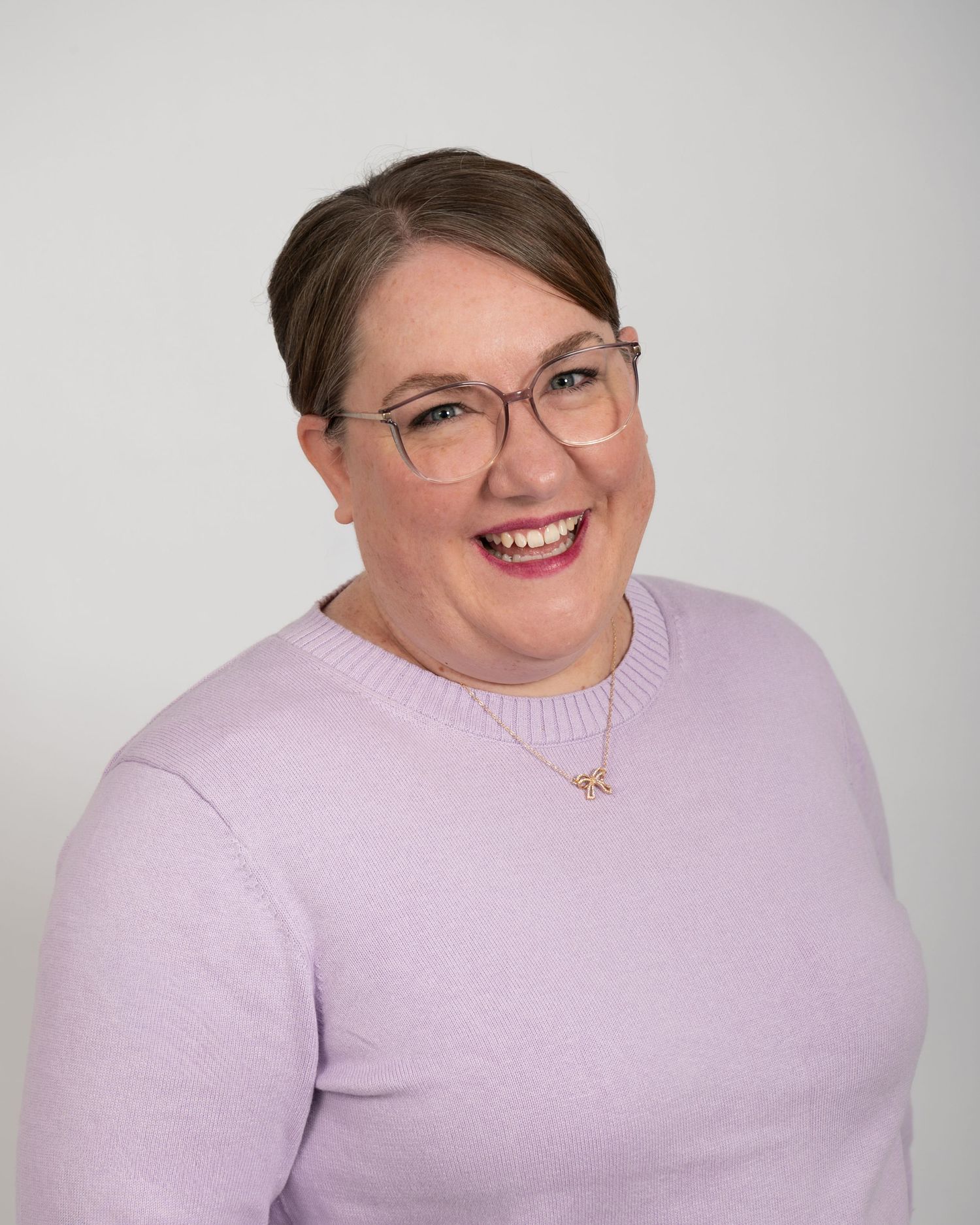 Studio headshot of smiling woman in glasses, ninefifteenphoto Meade County KY professional headshot photographer.
