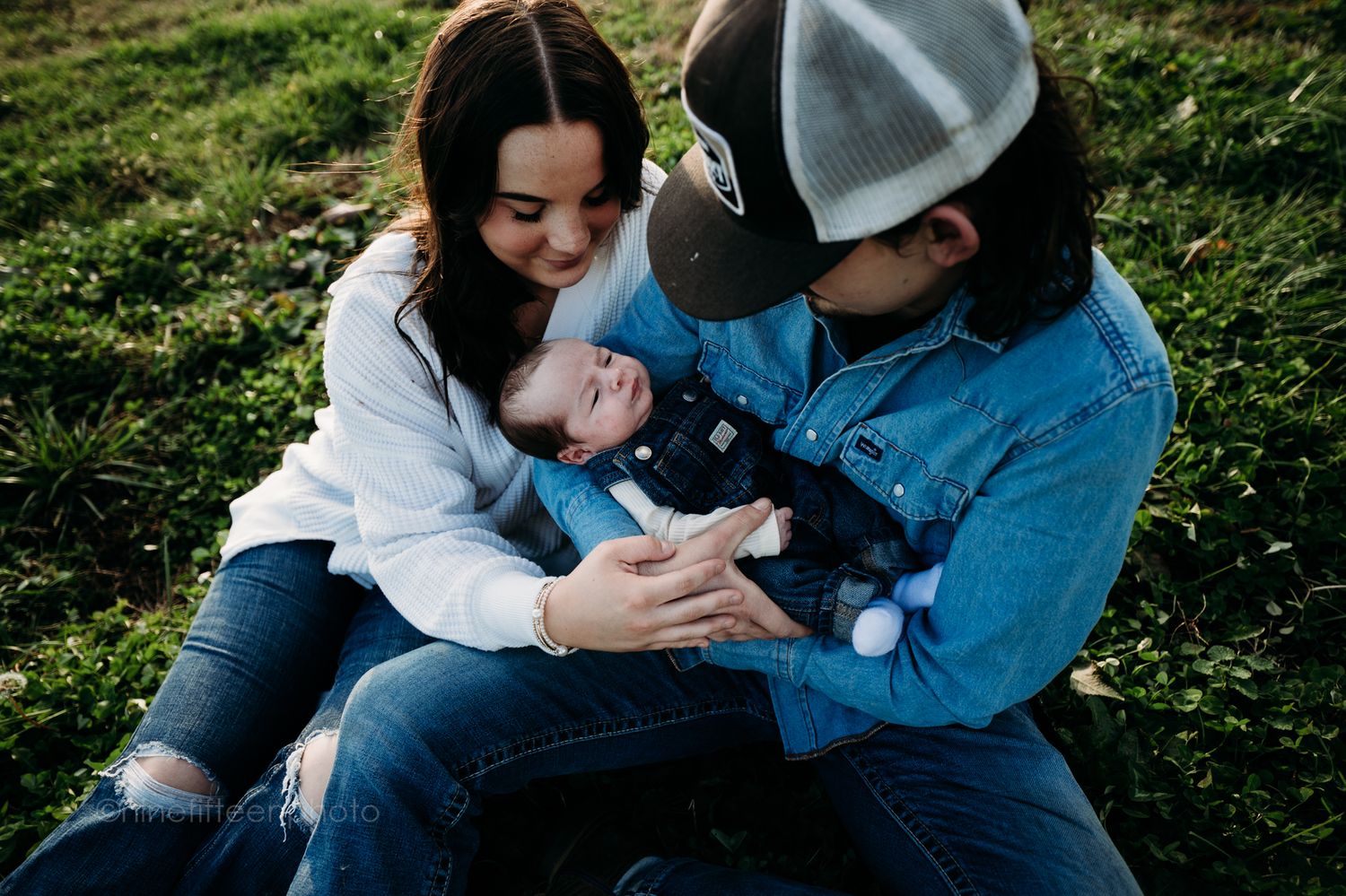 Custer KY newborn lifestyle photo of Kaylin and Caleb with their baby Devin, captured by ninefifteenphoto in rustic golden light.