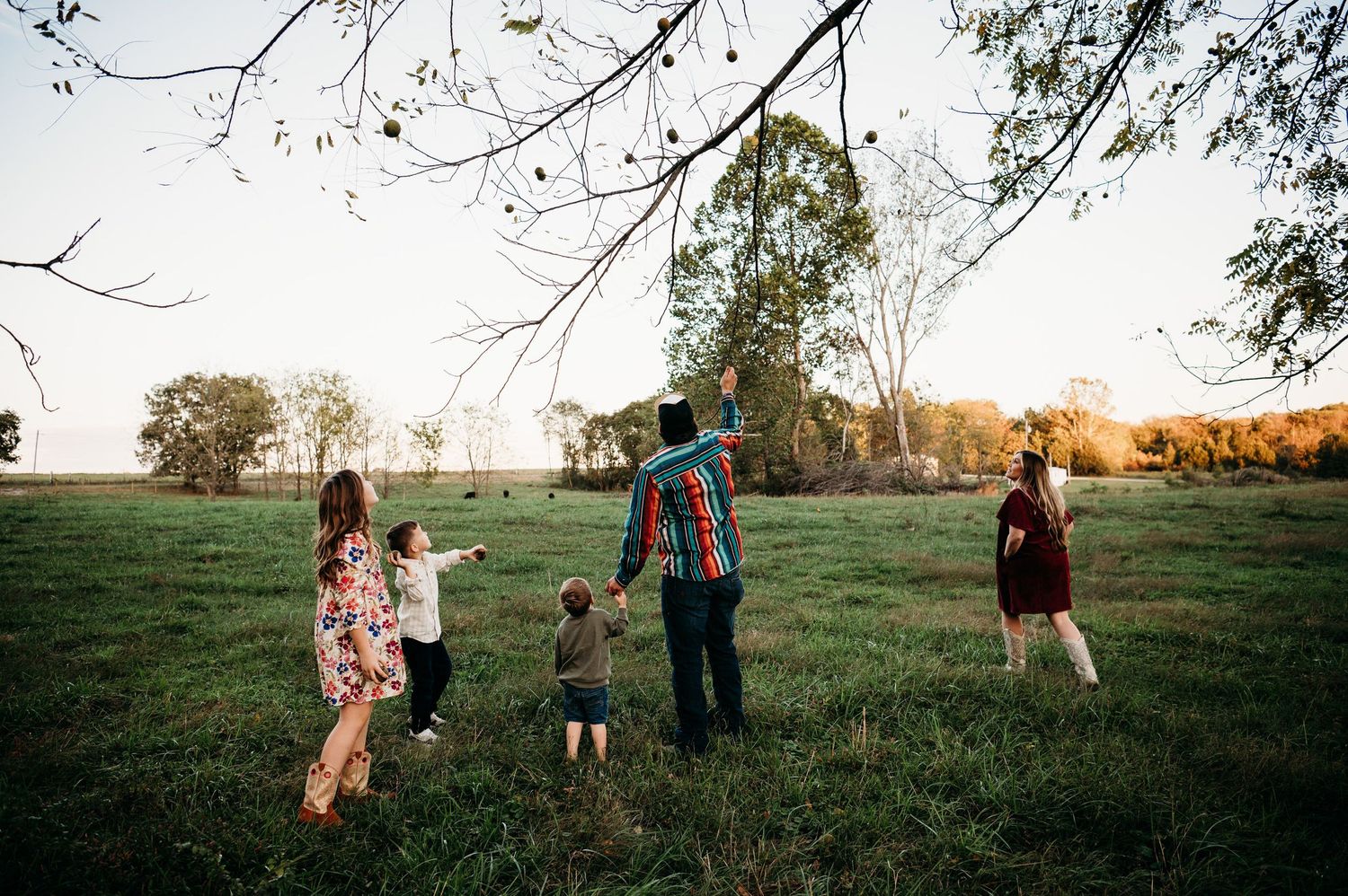 Family running through open field during warm golden hour in Guston Kentucky