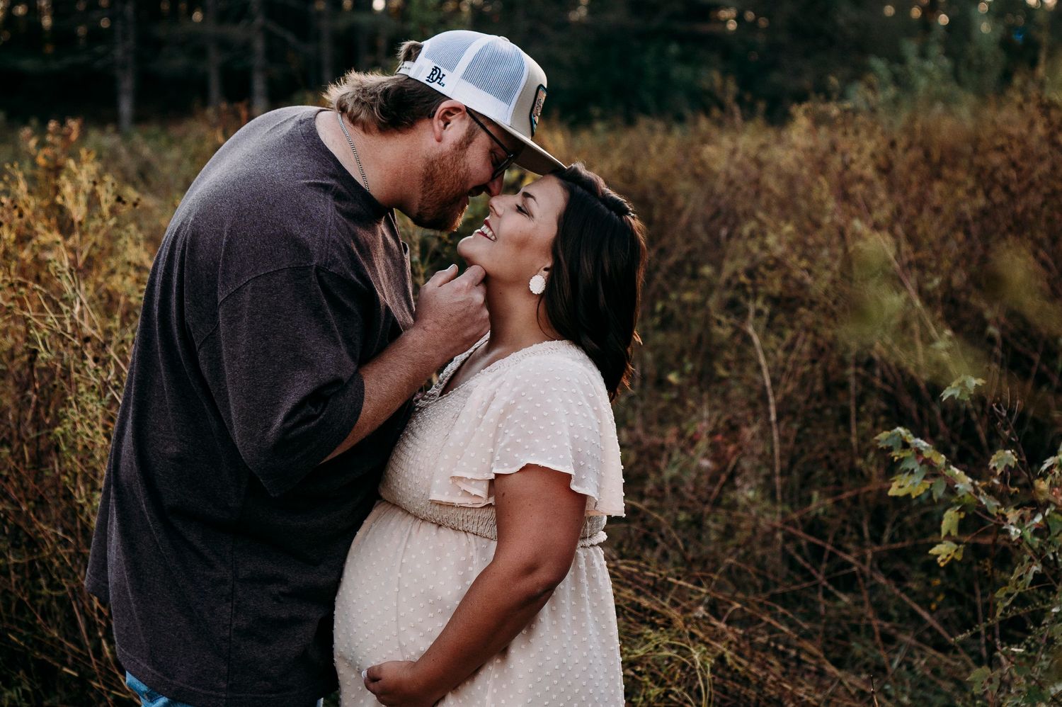 Couple laughing together during golden hour maternity photos Brandenburg KY