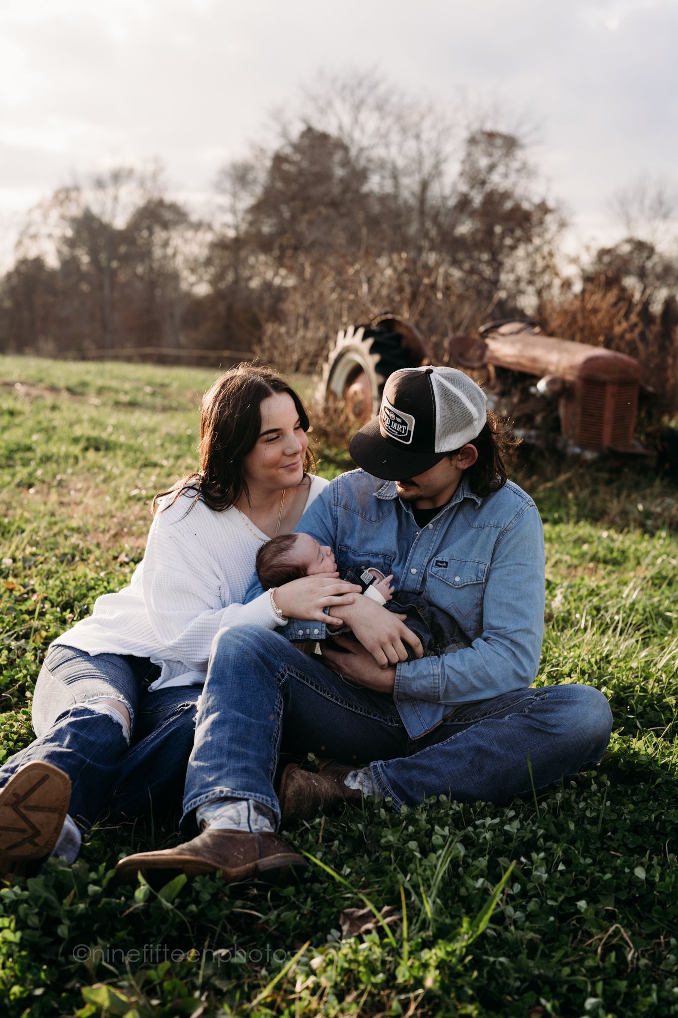 Custer KY newborn lifestyle photo of Kaylin and Caleb with their baby Devin, captured by ninefifteenphoto in rustic golden light.