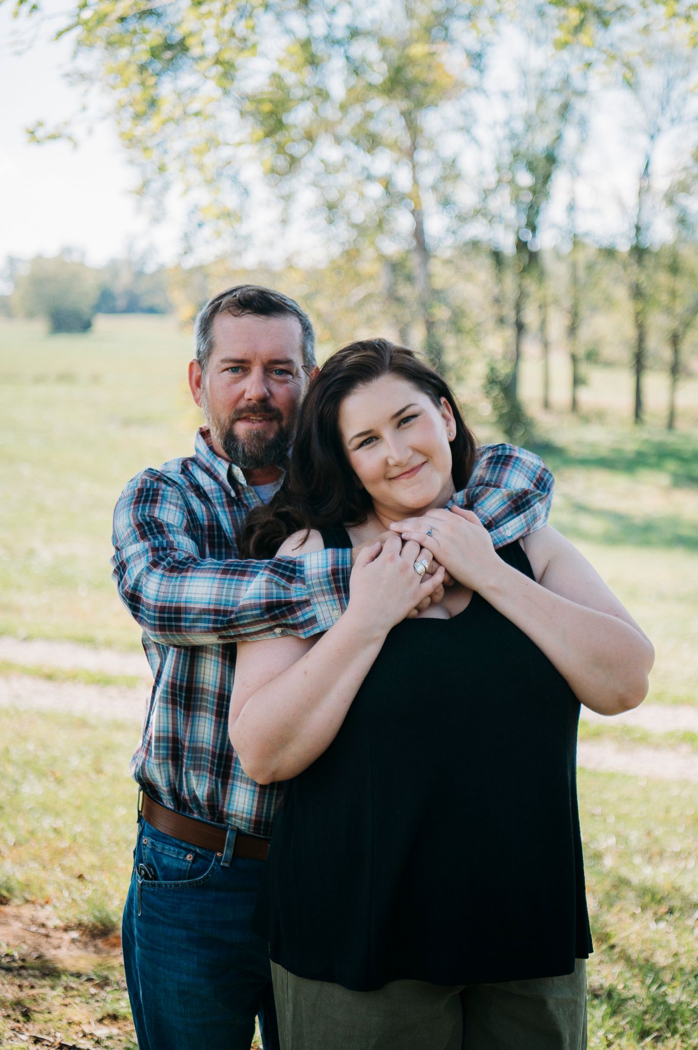 Outdoor couple portrait during a farmhouse family session in Battletown Kentucky photographed by ninefifteenphoto