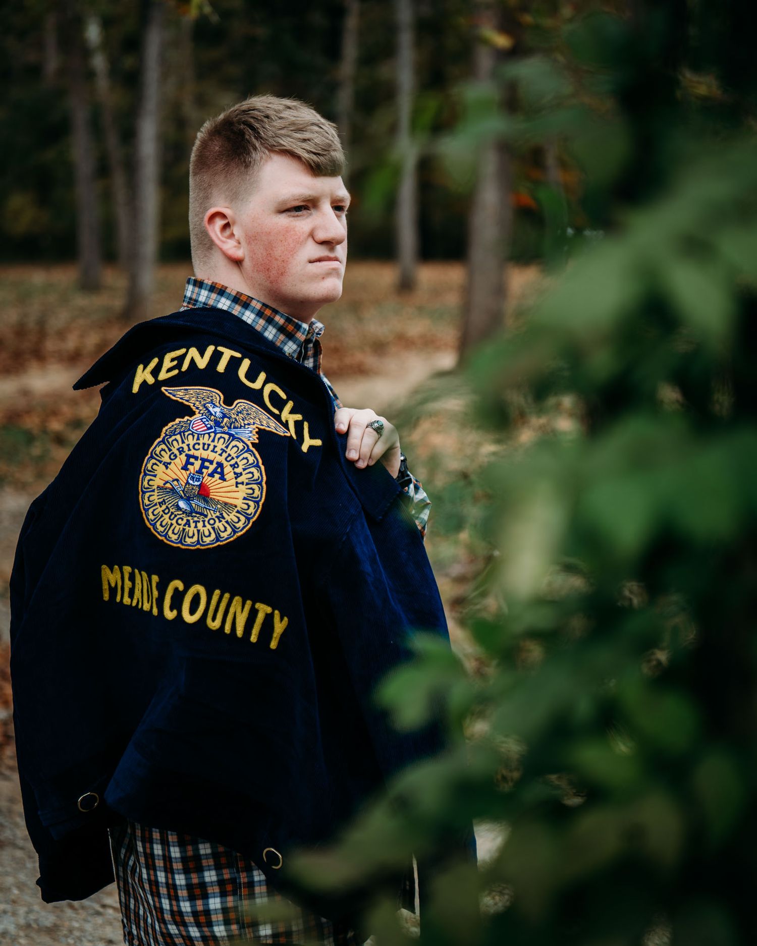 Mayson shows his Kentucky FFA jacket during his senior photos in Brandenburg Kentucky