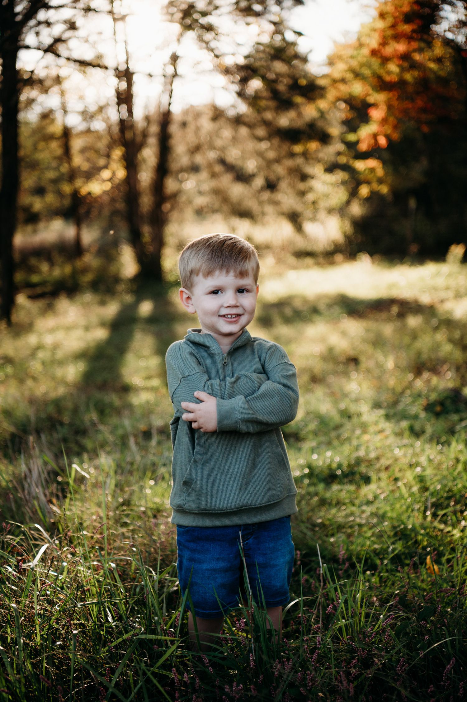 Smiling young boy in golden light during family photo session in Guston Kentucky