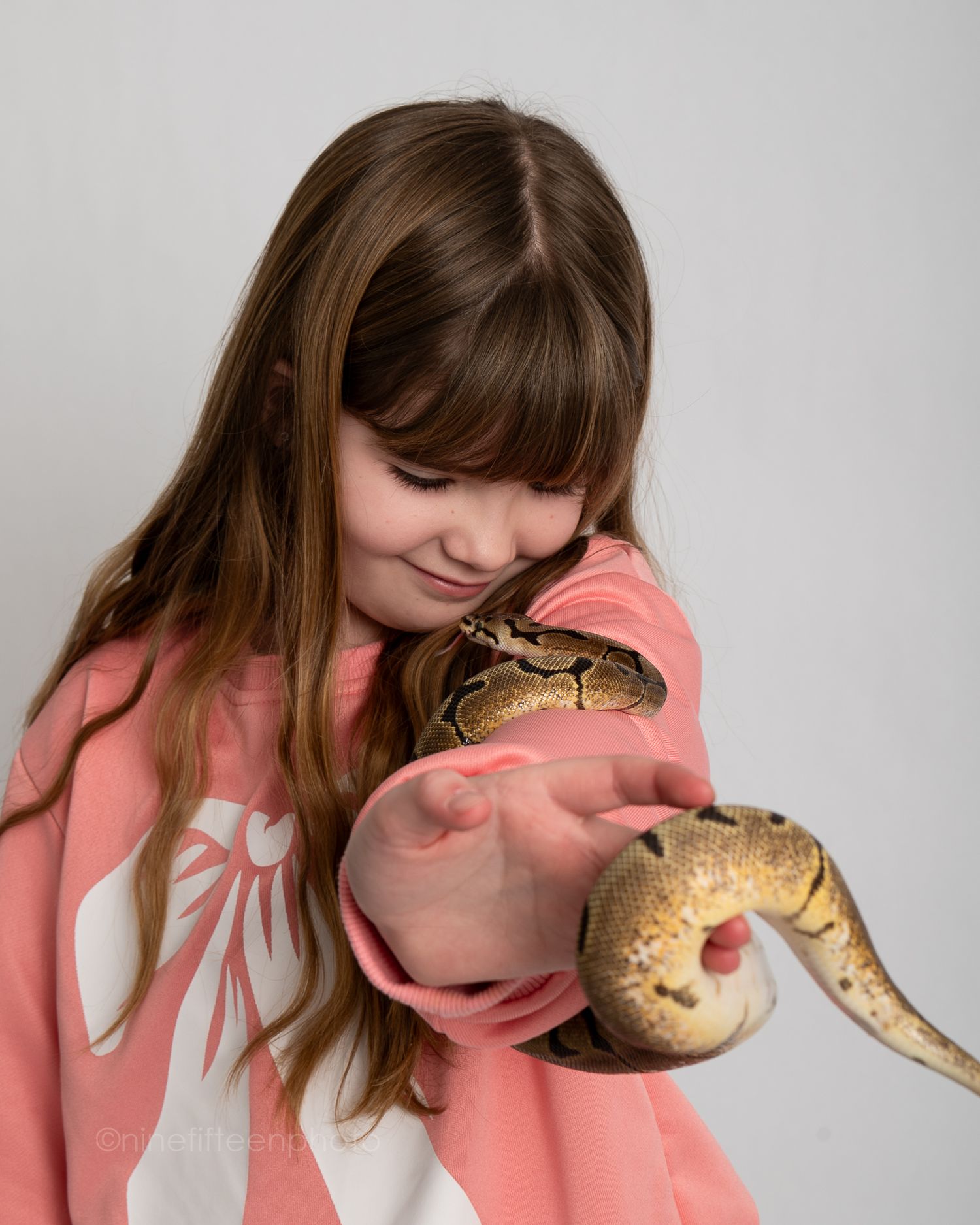Studio child portrait holding a pet snake, ninefifteenphoto Meade County KY kids photographer and pet portrait sessions.