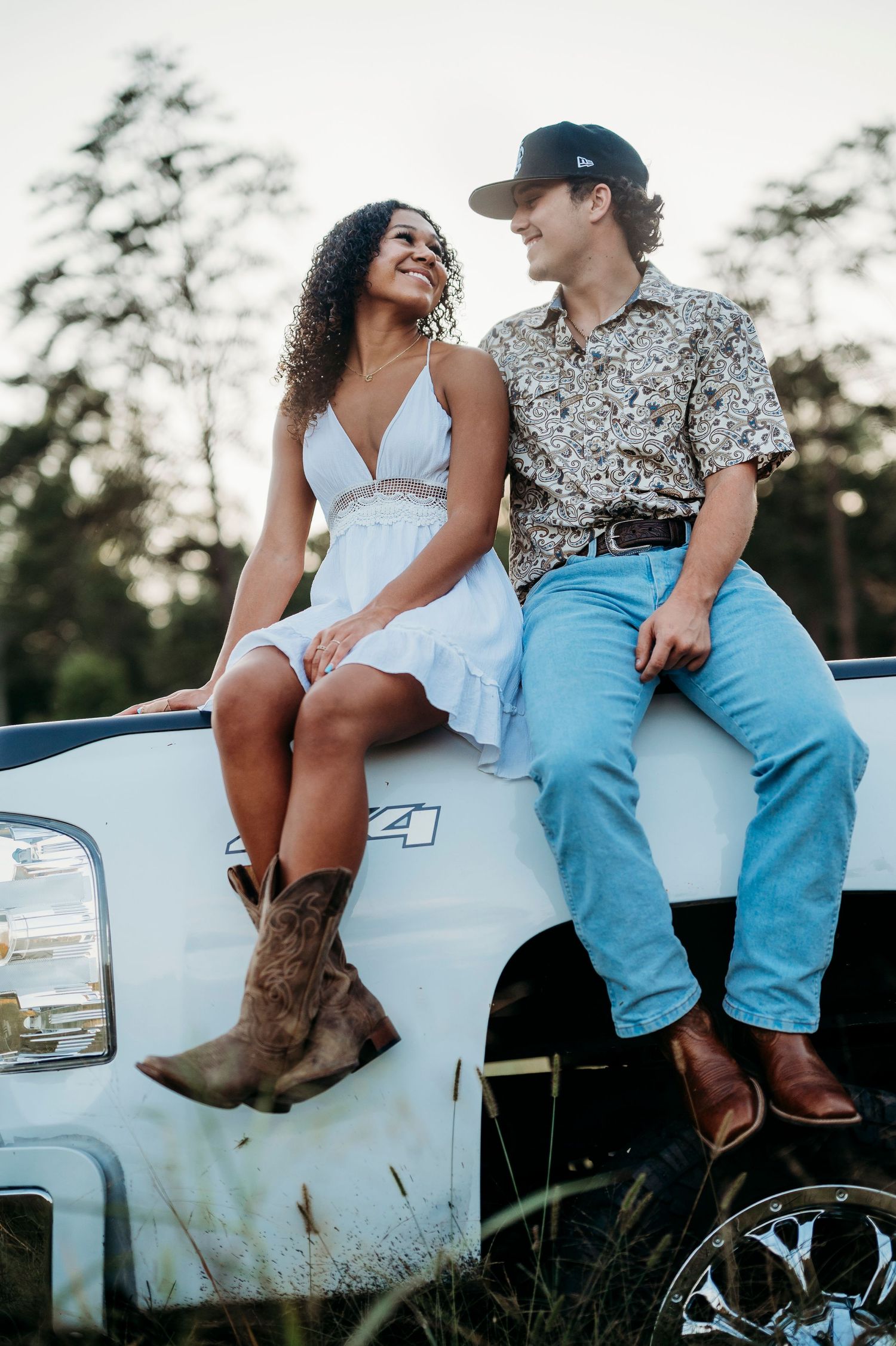 Bella and her boyfriend sitting on truck tailgate in Brandenburg Kentucky senior photo session by ninefifteenphoto
