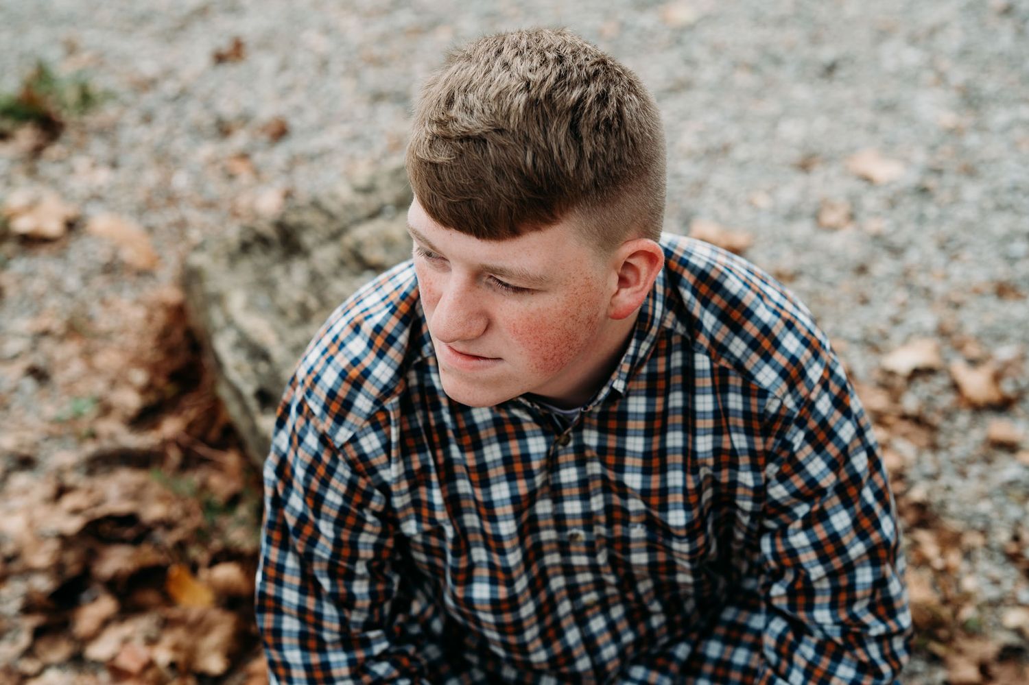 Close-up of Mayson during his outdoor fall senior session in Brandenburg Kentucky