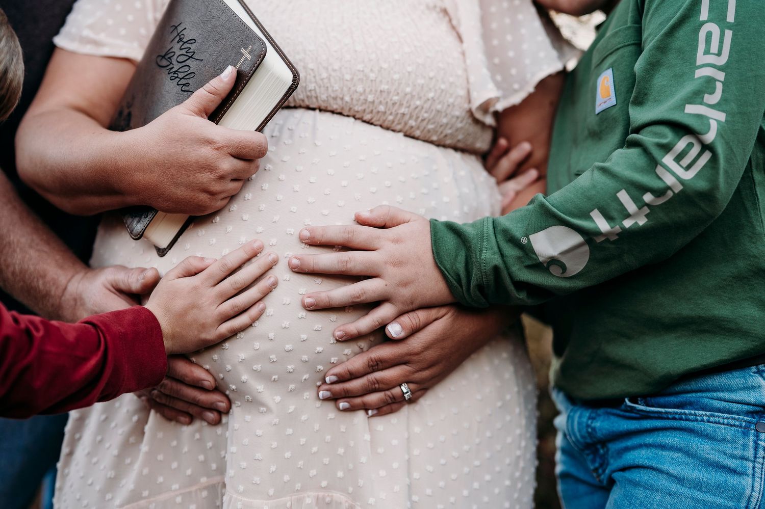 Hands on baby bump detail during outdoor fall maternity session Otter Creek KY