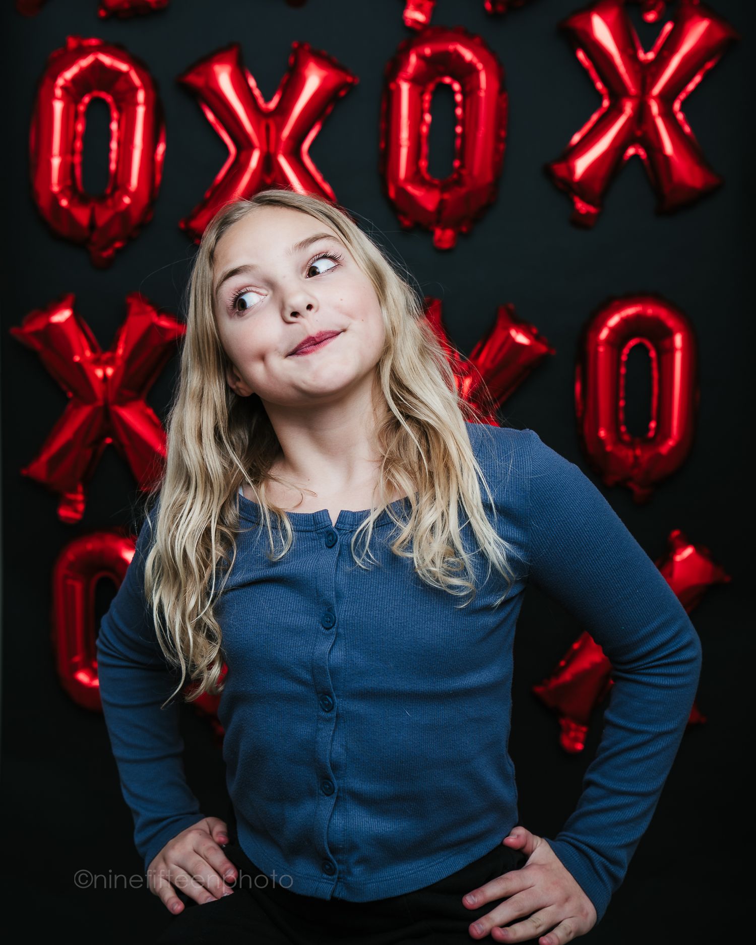 Creative studio portrait with red XOXO backdrop, ninefifteenphoto Brandenburg KY children photographer in Meade County.