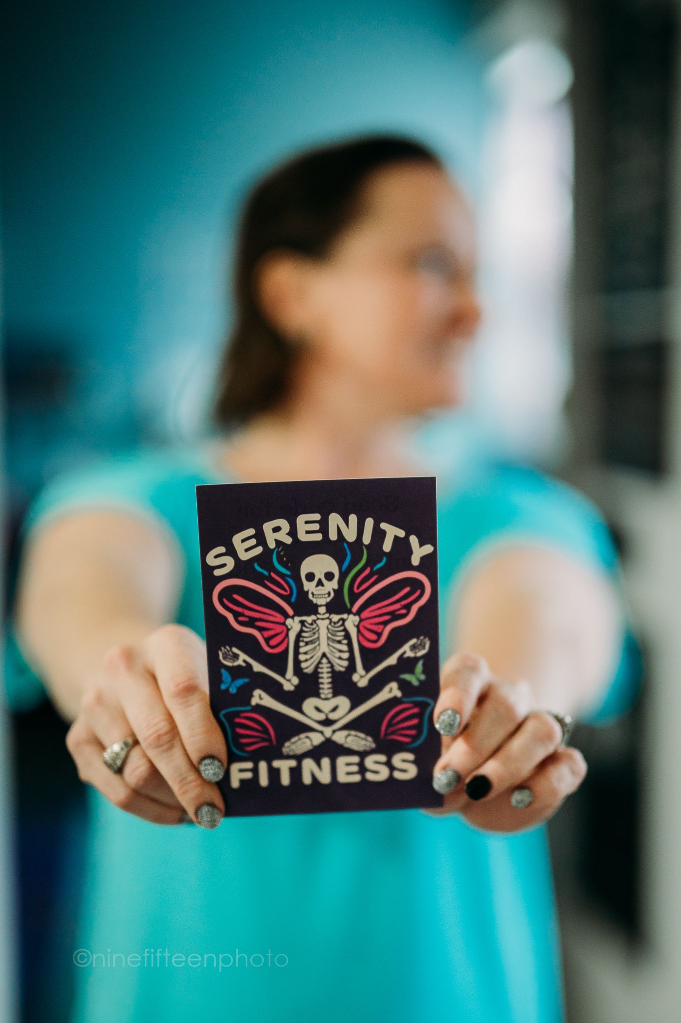 Branding photo of woman holding Serenity Yoga & Fitness logo, ninefifteenphoto Meade County KY business photography.