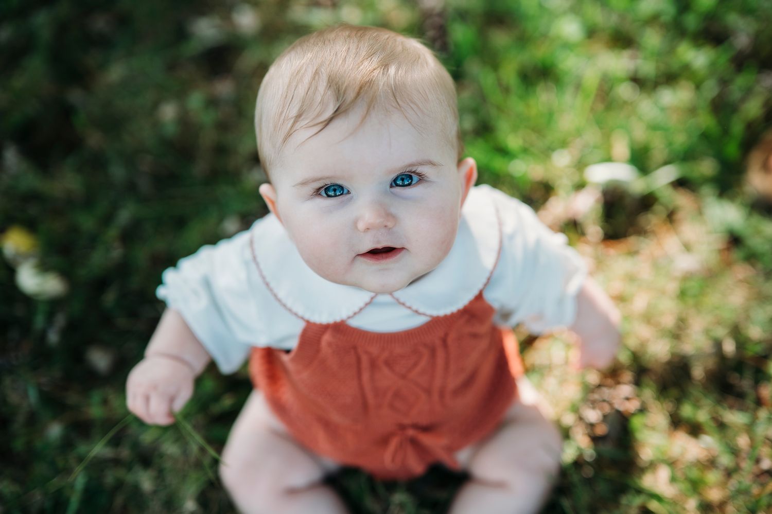 Adorable close-up of 8-month-old baby looking up during a Battletown Kentucky farmhouse session by ninefifteenphoto.