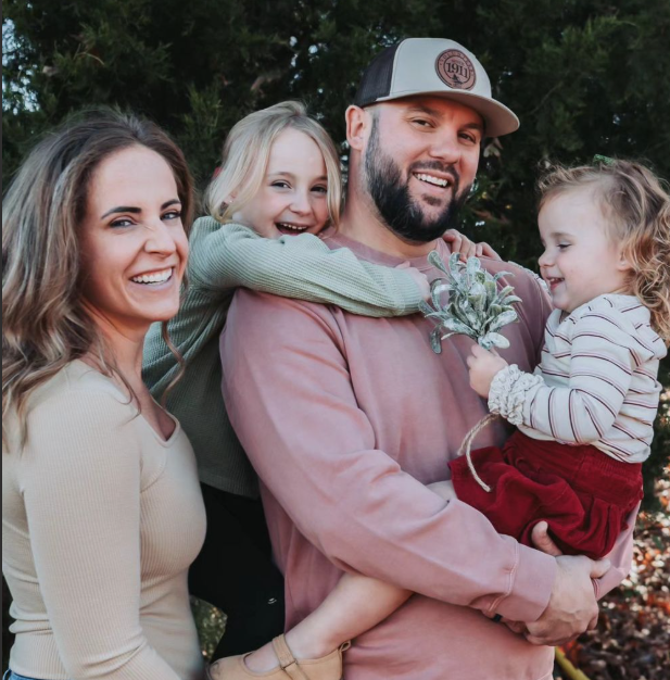 Smiling family embracing during outdoor photo session in Brandenburg KY.