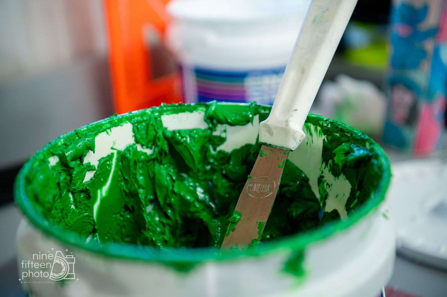 Close-up of green ink being mixed for custom screen printing at MC Screen Printing in Brandenburg.