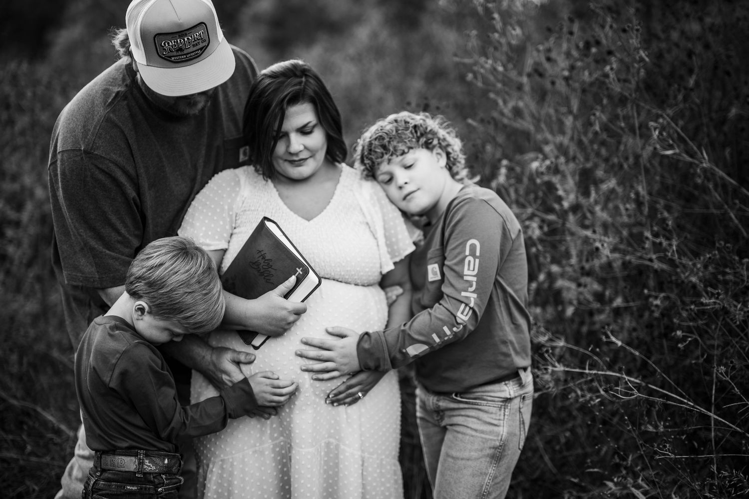 Family hugging and smiling during fall maternity session Brandenburg KY