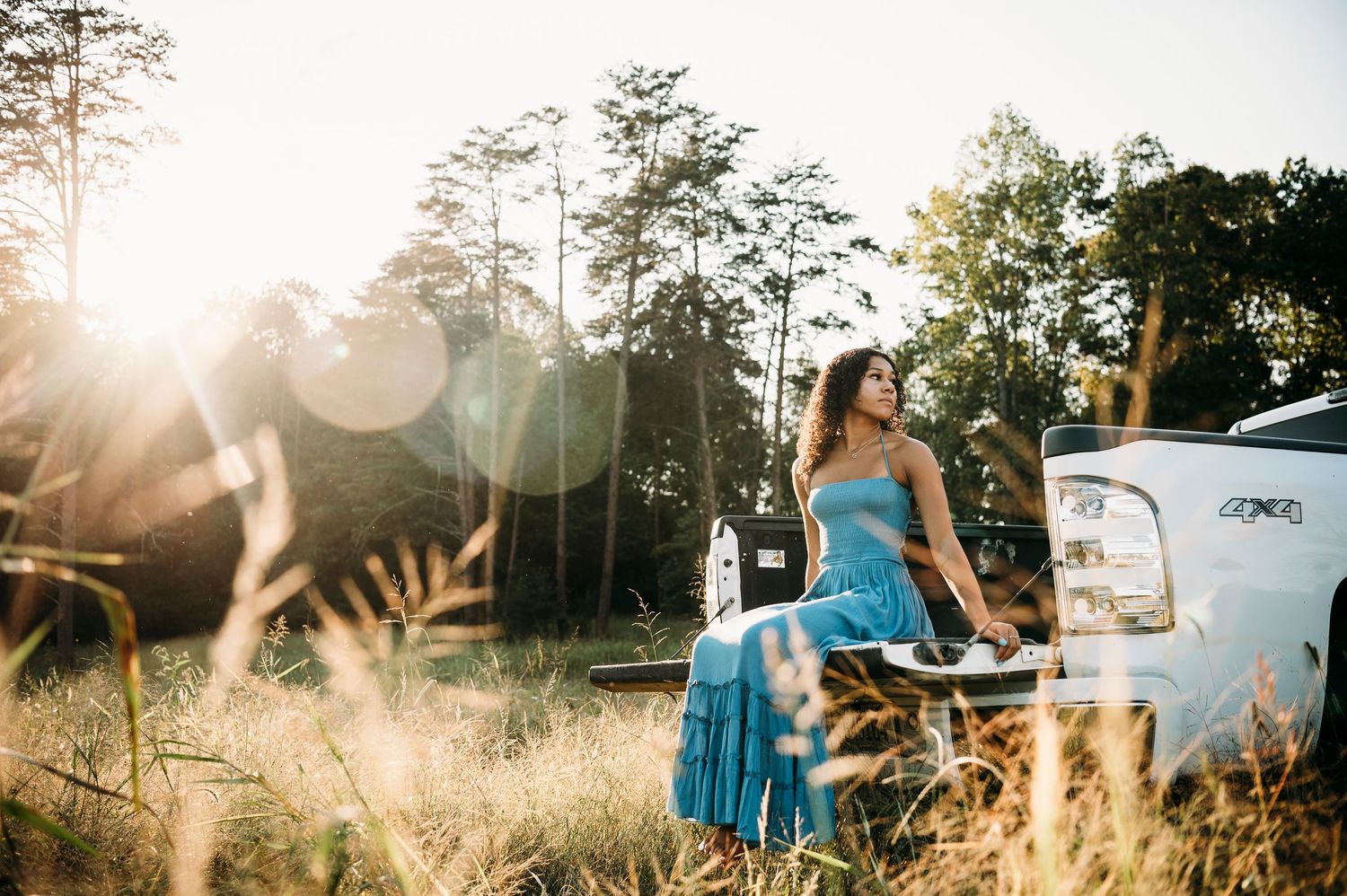 Country senior photos with Bella and her boyfriend by white truck in Brandenburg Kentucky field by ninefifteenphoto