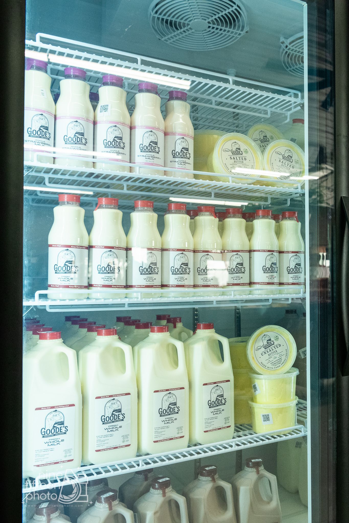 Refrigerator stocked with local milk, butter, and fresh farm goods inside Hardesty Farms market.