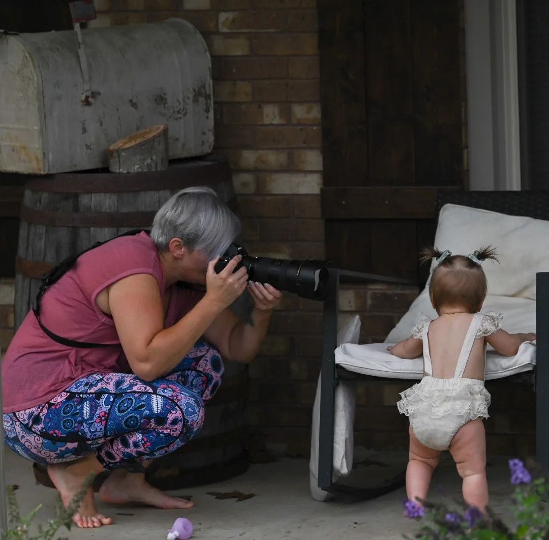 Photographer and child during a session, showing how sharing ideas leads to better results.