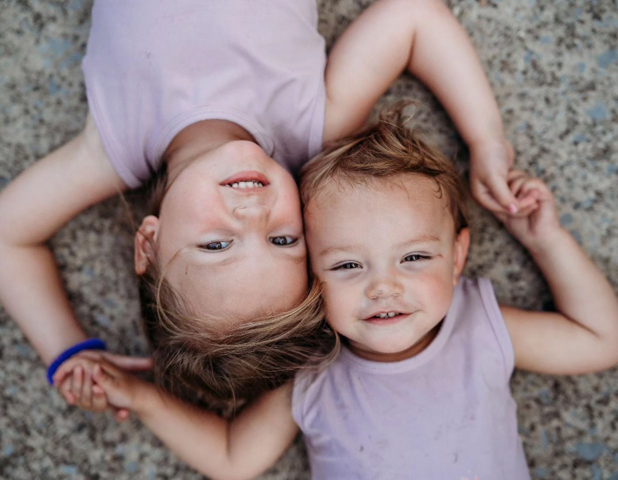Two sisters hugging and smiling during family photo session in Brandenburg KY.