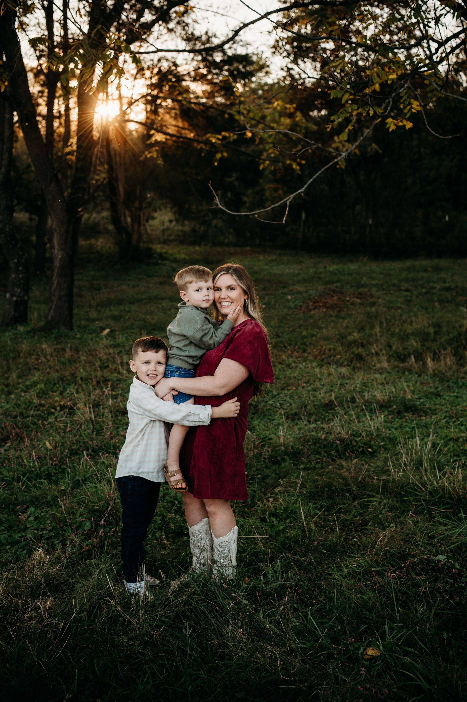 Mother and child hugging in sunset light during fall family session in Guston Kentucky